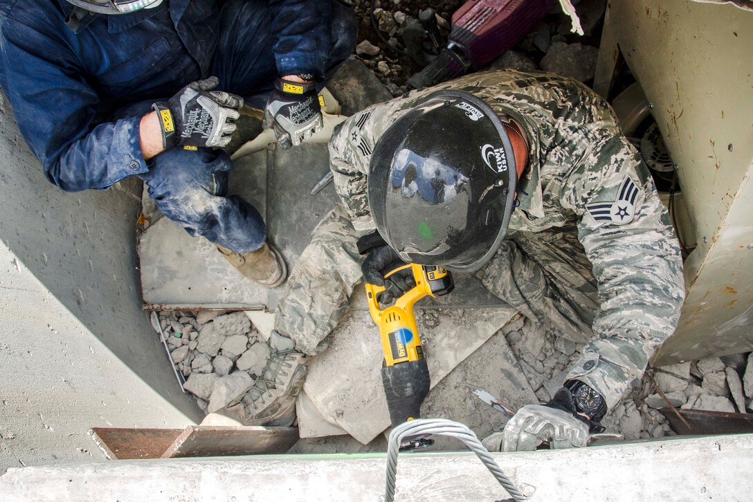 Air National Guardsmen use hammer drills and heavy-duty saws to make a hole in a concrete wall during a simulated search and rescue as part of the Patriot North exercise at Volk Field, Wis., July 18, 2017. Air National Guard photo by Master Sgt. Kellen Kroening