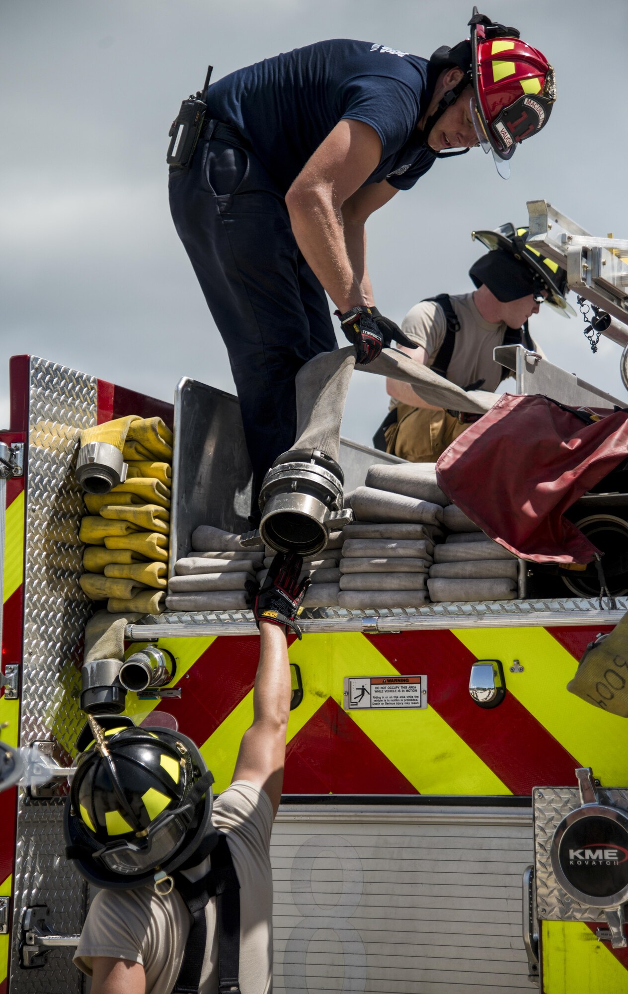 Stuart Vaughn, a fire protection crew chief assigned to the 6th Civil Engineer Squadron, assists in putting away a hose after a structural, live-burn exercise at MacDill Air Force Base, Fla., July 24, 2017. Vaughan was the safety officer during the exercise, ensuring the firefighters inside the burning building were safe at all times. (U.S. Air Force photo by Airman 1st Class Adam R. Shanks)