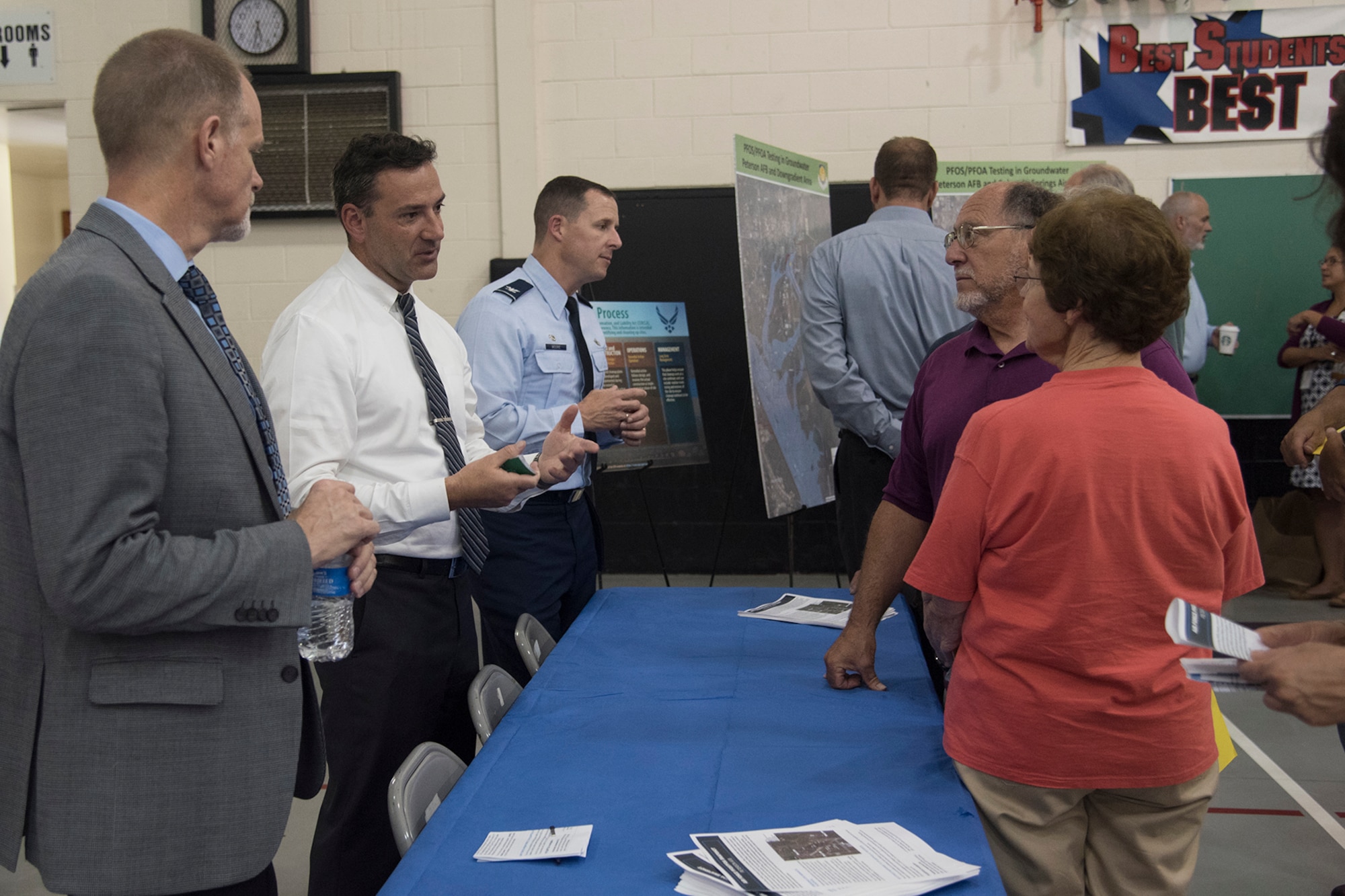 FOUNTAIN, Colo. – Cornell Long, Air Force Civil Engineer Center team lead, Fred Brooks, 21st CES environmental chief, and Col. Todd Moore, 21st Space Wing commander, answers Colorado Springs community members’ questions during an open house at Janitell Junior High School, July 25, 2017, Fountain, Colo. The open house was one of several AFCEC and 21st SW community engagements discussing the site inspection report released earlier that day covering an update on the perfluorooctane sulfonate and perfluorooctanoic acid contamination. They also met with key state and federal members during a closed-door meeting followed with a media roundtable and the open house. (U.S. Air Force photo by Staff Sgt. Tiffany Lundberg)