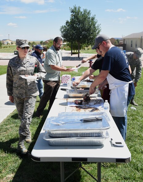 50th Mission Support Group resiliency picnic attendees line up for food at Schriever Air Force Base, Colorado, Wednesday, July 26, 2017. Food options included tri-tip steak, side dishes, fruit and a variety of desserts. (U.S. Air Force photo/Senior Airman Arielle Vasquez)