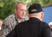 Staff Sgt. David Clark, III, visits with veterans a volunteer event at the Lowell Veterans Community Care Center July 26. During the event, Hanscom volunteers prepared and served more than 120 meals and then met with veterans as part of the daylong effort. (U.S. Air Force photo by Mark Herlihy)