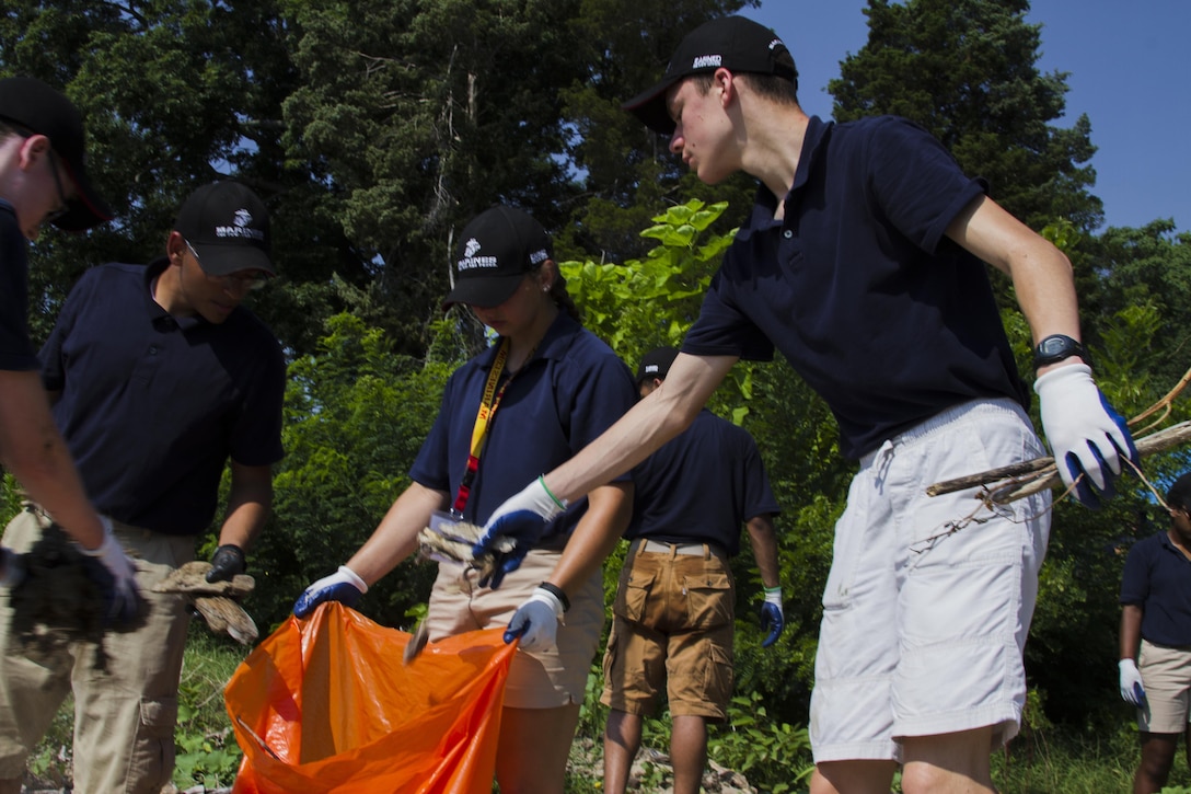 Chris Escamilla picks up trash with other high school students as part of a community service project at a beach during the 2017 Summer Leadership and Character Development Academy (SLCDA) aboard Quantico, Va., July 21. The SLCDA is a six-day-long program focused on teaching high school students skills critical to future success, such as honor, courage and commitment. Escamilla travelled approximately 7,000 miles overseas from Naval Air Facility, Atsugi, Japan, to Quantico to attend the event, and is a student at Zama American High School.