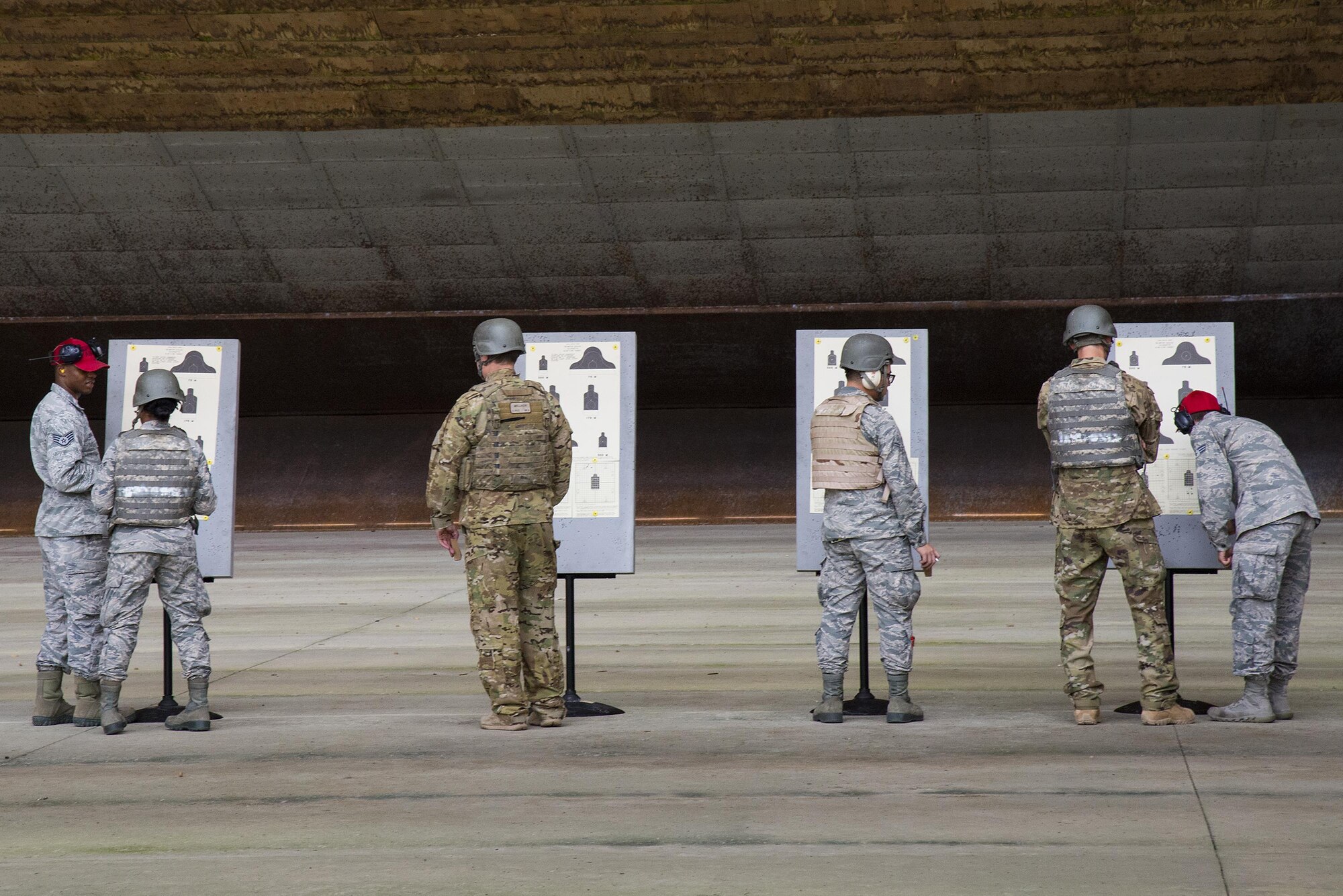 Airmen analyze their targets at the Combat Arms Training and Maintenance range, July 25, 2017, at Moody Air Force Base, Ga. During CATM, Airmen must demonstrate quality safety standards while handling and shooting their weapons in order to qualify to deploy. (U.S. Air Force photo by Airman 1st Class Erick Requadt)