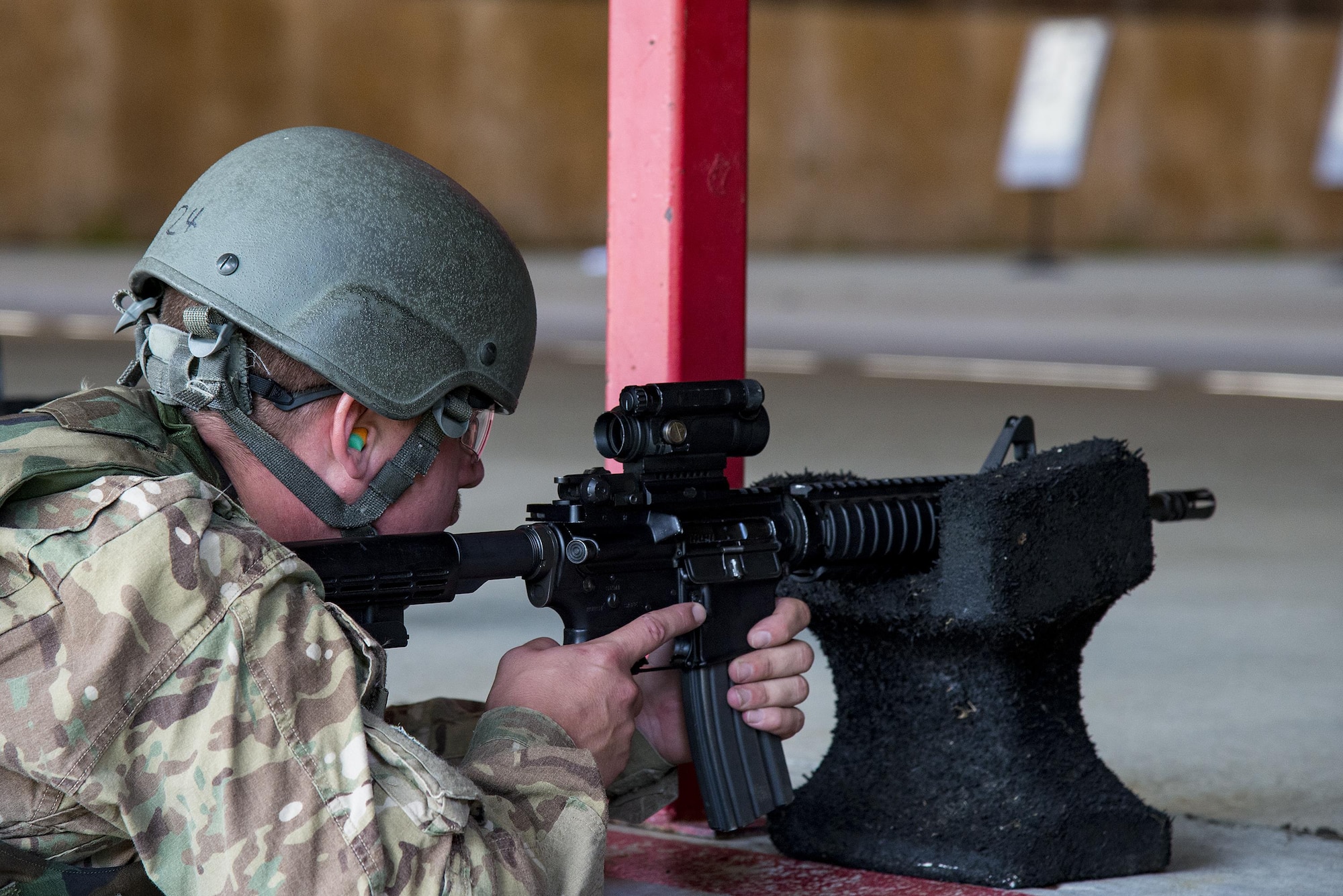 Senior Airman Donald Sweeney, 41st Rescue Squadron HH-60G Pave Hawk crew chief, looks through his sight as he fires his M4 carbine, July 25, 2017, at the Combat Arms Training and Maintenance range at Moody Air Force Base, Ga. During CATM, Airmen must demonstrate quality safety standards while handling and shooting their weapons in order to qualify to deploy. (U.S. Air Force photo by Airman 1st Class Erick Requadt)