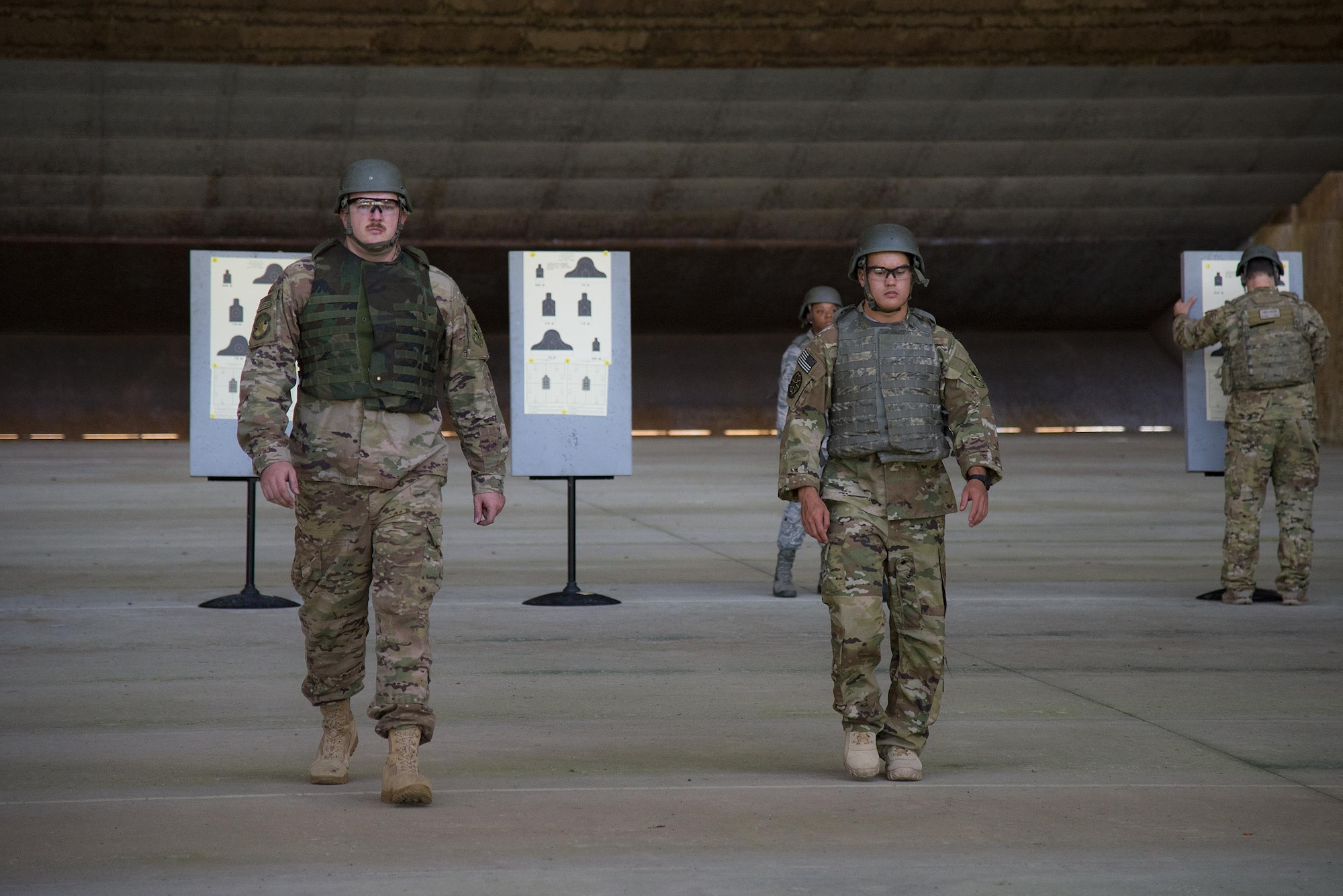 Airmen walk back after placing their targets at the Combat Arms Training and Maintenance range, July 25, 2017, at Moody Air Force Base, Ga. During CATM, Airmen must demonstrate quality safety standards while handling and shooting their weapons in order to qualify to deploy. (U.S. Air Force photo by Airman 1st Class Erick Requadt)