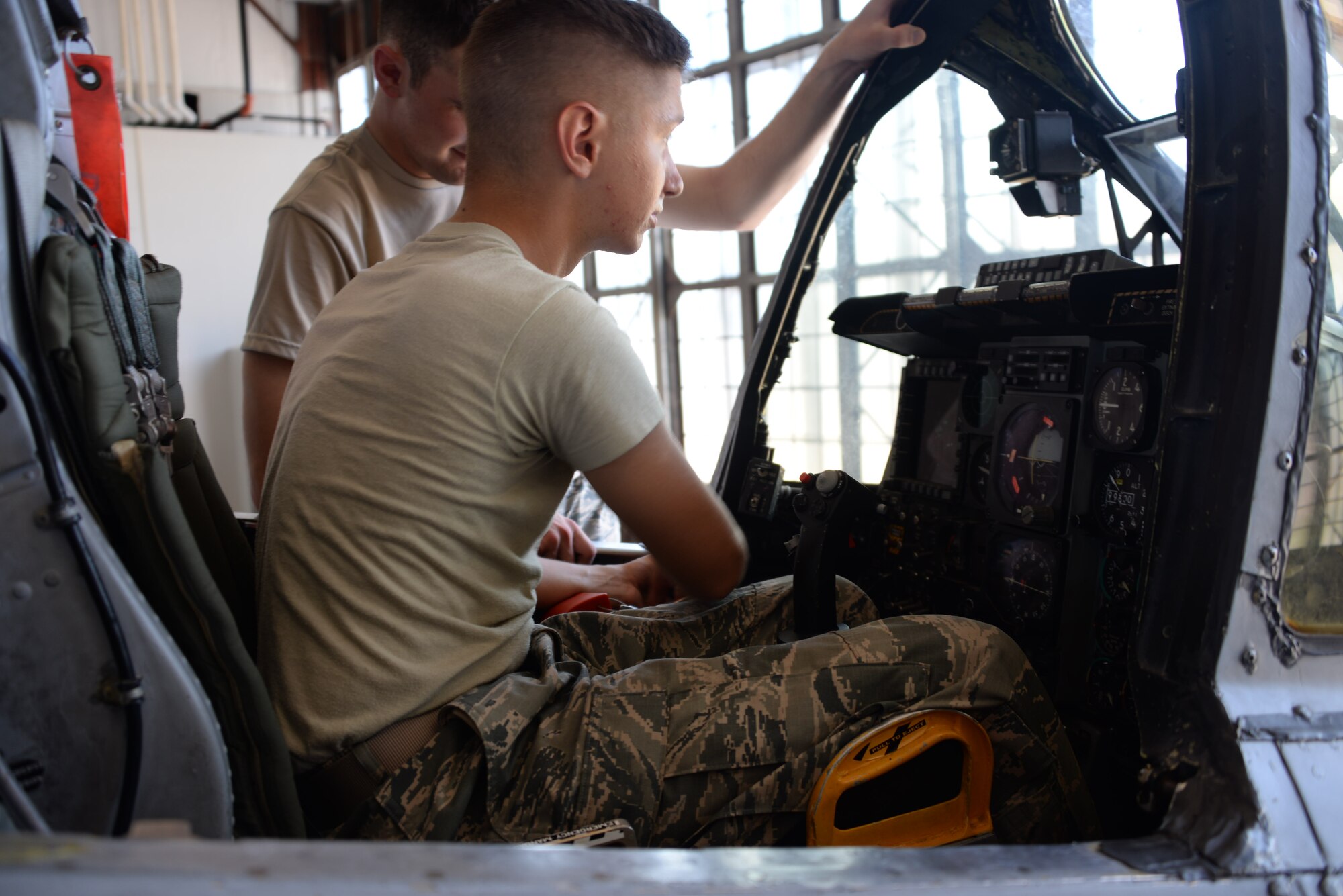 Airmen Corbin Broglio and Tryston Stanfield, 362nd Training Squadron A-10 crew chief apprentice course students, work on raising the windshield to allow access to the avionics boxes. Avionics boxes would need to be accessible during and electronic malfunction. (U.S. Air Force phot by Senior Airman Robert L. McIlrath)