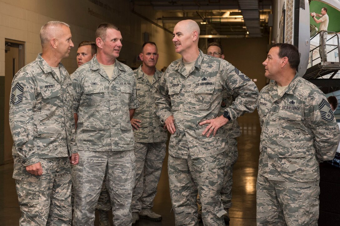 Air National Guard Command Chief, Chief Master Sgt. Ronald Anderson, second from right, talks with 167th Airlift Wing maintenance chiefs, Chief Master Sgt. Todd Kirkwood, Chief Master Sgt. Richard Long, and Chief Master Sgt. Keith Foreman during his visit to the Martinsburg, W.Va. air base, July 26. Lt. Gen. L. Scott Rice, Director of the Air National Guard and Anderson, toured the 167th Airlift Wing and met with Airmen. West Virginia National Guard Adjutant General, Maj. Gen. James A. Hoyer, Assistant Adjutant General for Air, Brig. Gen. Paige Hunter, and State Command Chief, Chief Master Sgt. James Dixon joined the ANG leadership on the tour of the Martinsburg air base. Before visiting the 167AW, Rice and Anderson visited the National Boy Scouts Jamboree in Glen Jean, W.Va., and the 130th Airlift Wing in Charleston, W.Va. (U.S. Air National Guard photo by Senior Master Sgt. Emily Beightol-Deyerle)