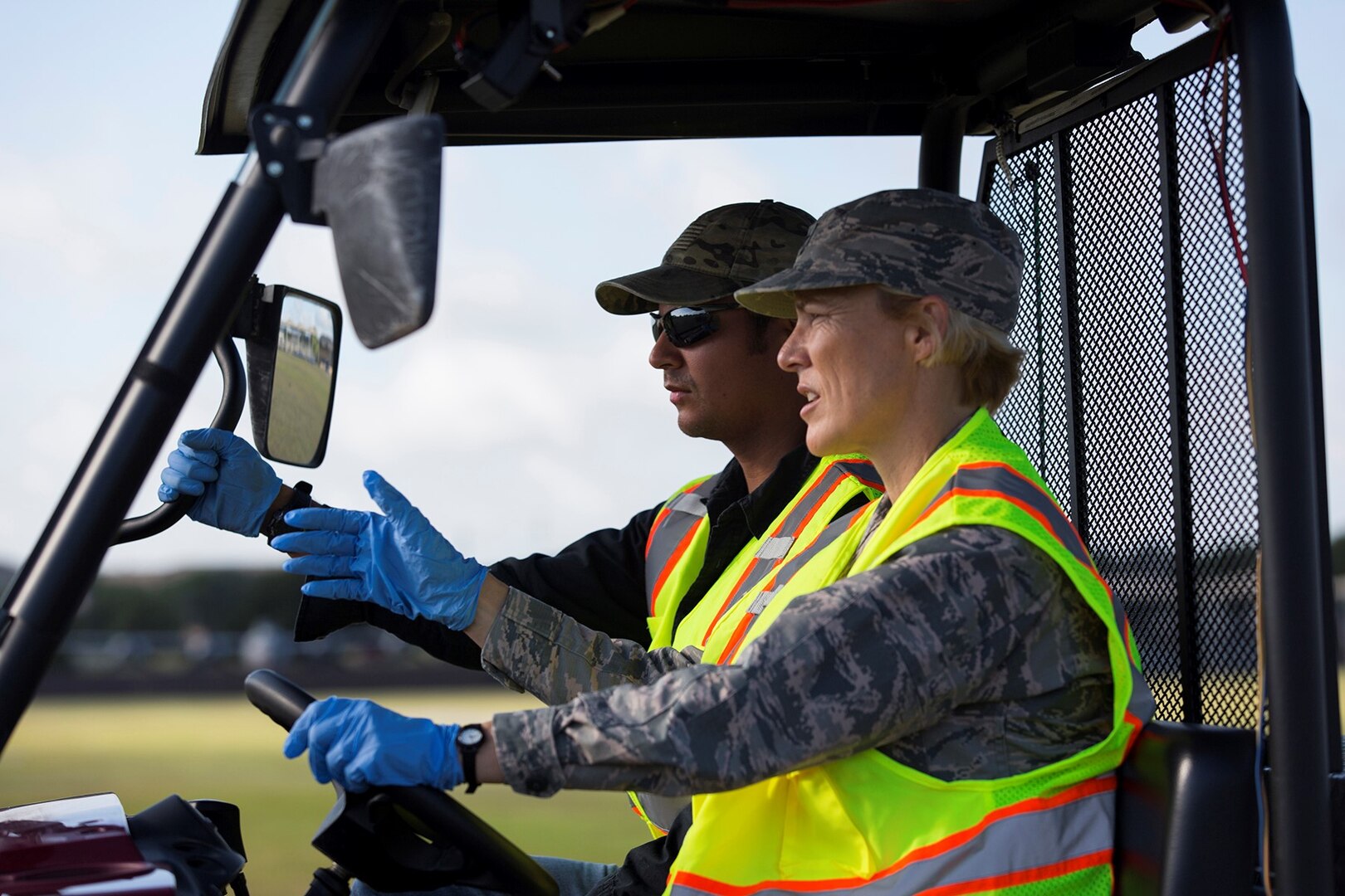 From right to left. Brig. Gen. Heather Pringle, 502nd Air Base Wing and Joint Base San Antonio commander, and Jorge Ortiz, 502nd Civil Engineer Squadron Pest Management pest control technician, spread ant bait on a parade field at JBSA-Lackland, Texas, July 20, 2017. Senior leadership from 502nd ABW and JBSA accompanied the 502nd CES Pest Management pest control technicians as they completed work orders and took measures to keep the insect and animal population in check throughout the installation.