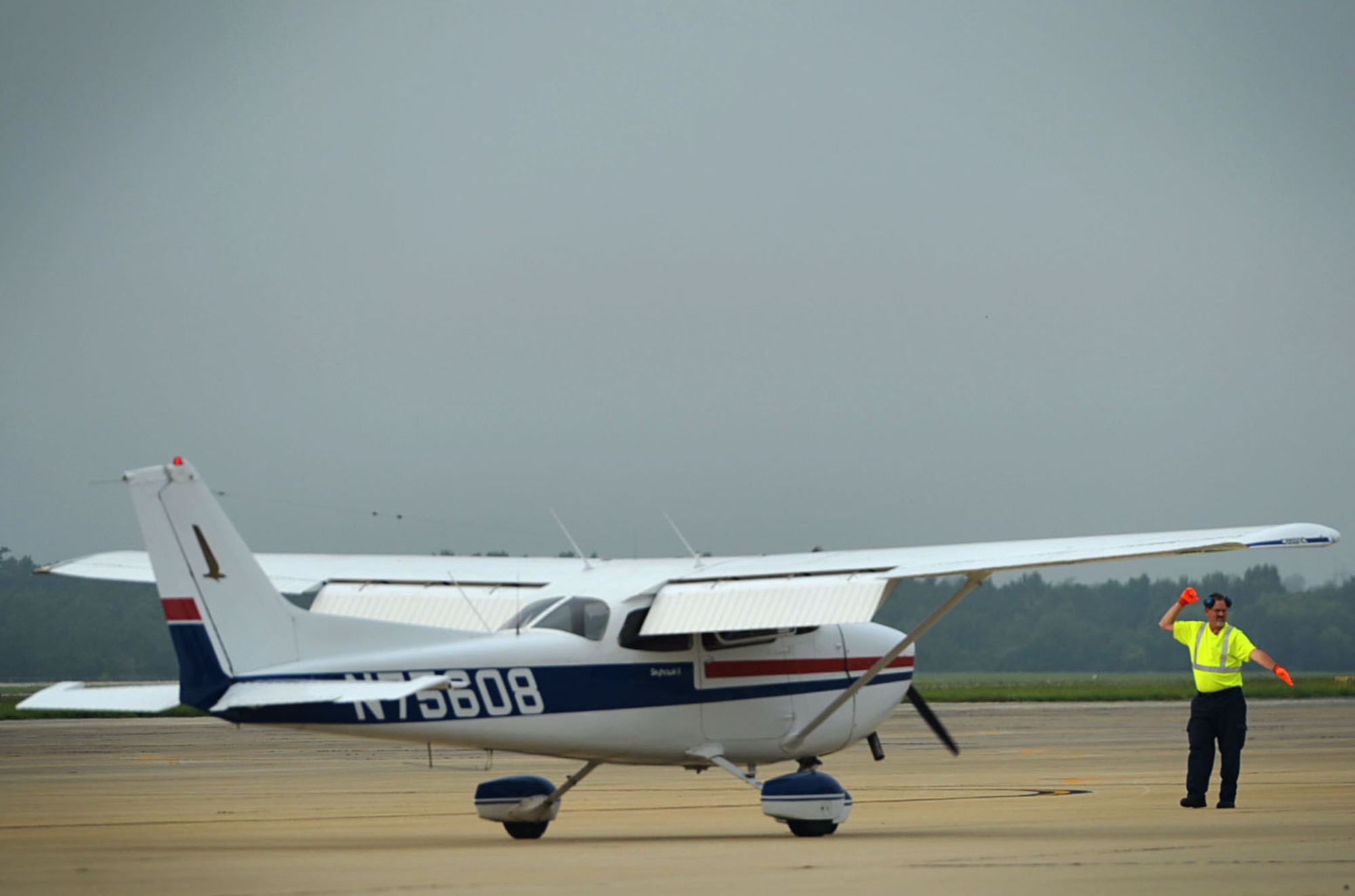 Tim Darrah, 20th Equipment Maintenance Squadron aircraft servicer, marshals a civilian Cessna 172, during a General Aviation Fly-in event at Shaw Air Force Base, S.C., July 28, 2017. The event gave the local aviation community an opportunity to land aircraft at Shaw and learn about the 20th Fighter Wing mission. (U.S. Air Force photo by Senior Airman Christopher Maldonado)