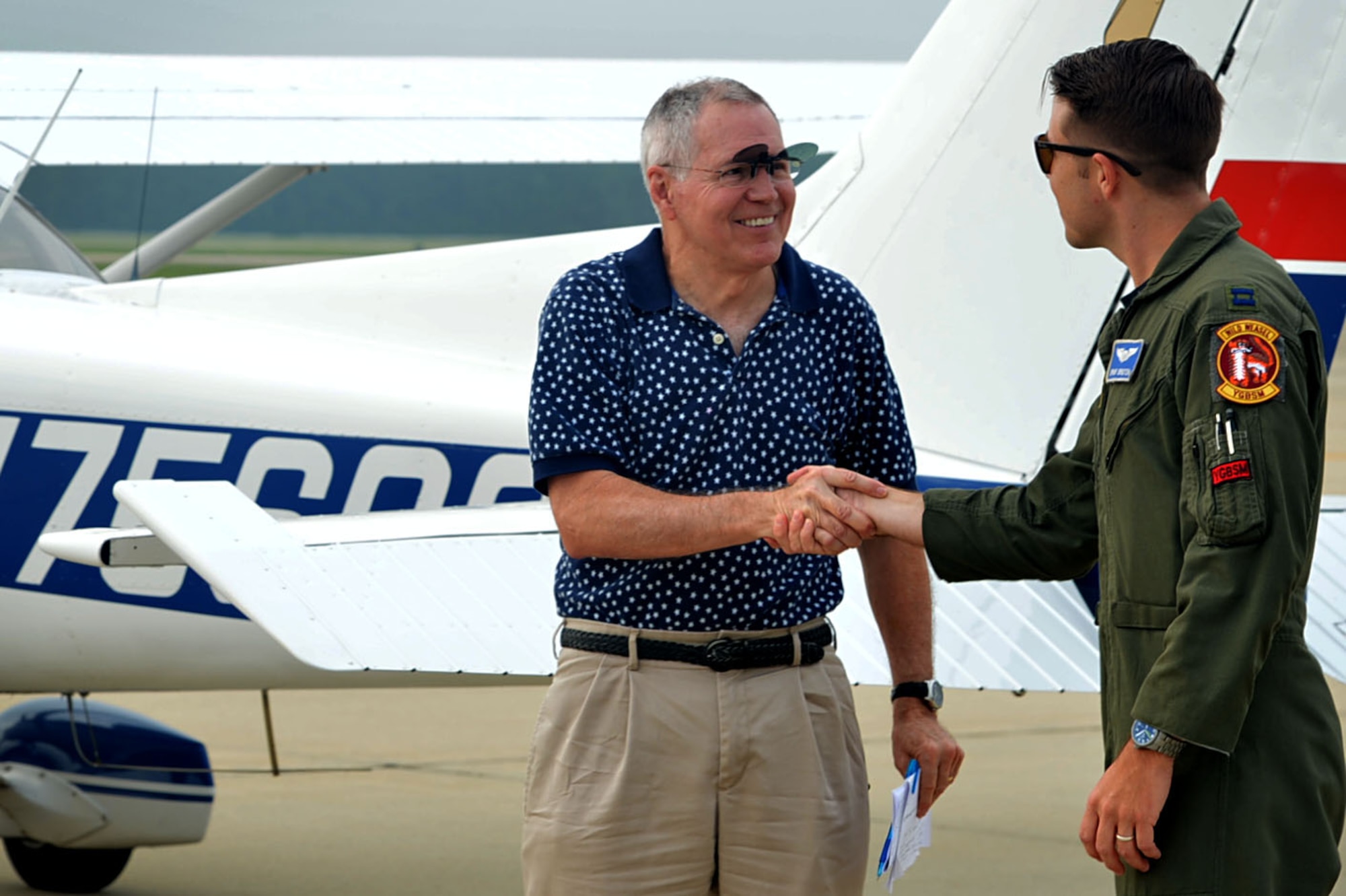 U.S. Air Force Capt. Kyle Bruton, 20th Fighter Wing flight safety chief, greets James Counts, Cessna 172 pilot, during a General Aviation Fly-in event at Shaw Air Force Base, S.C., July 28, 2017. Local aviators received the opportunity to talk to pilots and Airmen about current and future flying conditions. (U.S. Air Force photo by Senior Airman Christopher Maldonado)