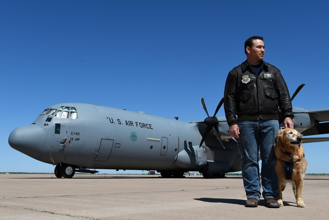 U.S. Air Force Airman 1st Class Clay Luthy (Sep.), a veteran loadmaster for the C-130E and C-130H, and his service dog, Charlotte, fell into media attention after he and his service dog, Charlotte, were hired by Lowe’s. A customer took a picture of Luthy with Charlotte laying at his feet and quickly posted the snapshot to social media, which set the spotlight for not only Luthy and Charlotte, but for veterans and service dogs everywhere. (U.S. Air Force photo by Airman 1st Class Emily Copeland)