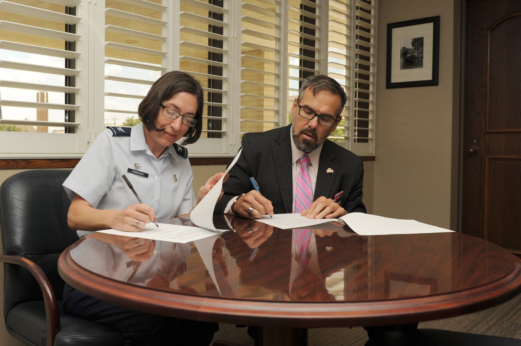 U.S. Air Force Col. Janet Urbanski, 17th Medical Group Commander, and Shane Phymell, Shannon Medical Center chief executive officer, sign a memorandum of agreement at the Shannon Medical Clinic in San Angelo, Texas, July 21, 2017. The agreement allows Goodfellow Air Force Base and Shannon medical professionals to use each other’s resources, providing higher quality training environment. (U.S. Air Force photo by Senior Airman Scott Jackson/Released)