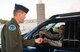 Col. Jefferson O’Donnell, 366th Fighter Wing commander, checks the ID of an airman driving through the main gate of Mountain Home Air Force Base, Idaho, May 5, 2017. 100% ID check is a standard routine here at the base since 2015. (U.S. Air Force photo by Senior Airman Malissa Armstrong/Released)