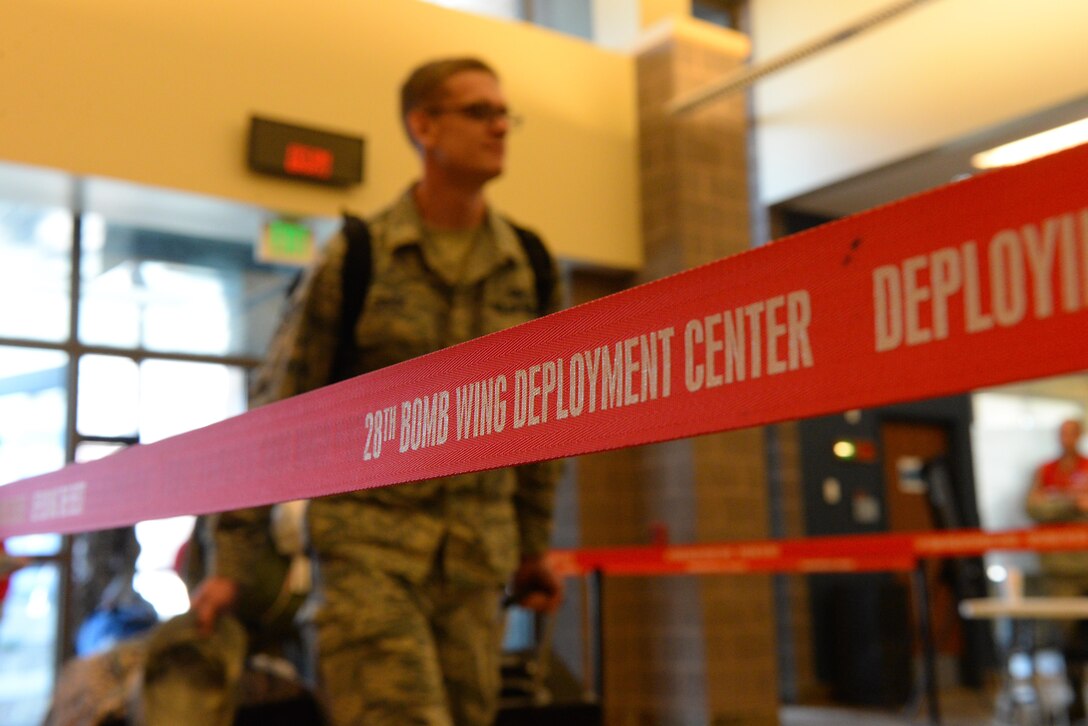 Airmen from the 28th Bomb Wing at Ellsworth Air Force Base, S.D., process through a deployment line prior to boarding a C-5M Super Galaxy bound for Andersen Air Force Base, Guam, in support of Continuous Bomber Presence operations in the Pacific theater, July 22, 2017. Ellsworth takes the baton from the 9th Expeditionary Bomb Squadron, Dyess Air Force Base, Texas, as the B-1 Bomber operators in the Pacific.  (U.S. Air Force photo by Airman Nicolas Z. Erwin)