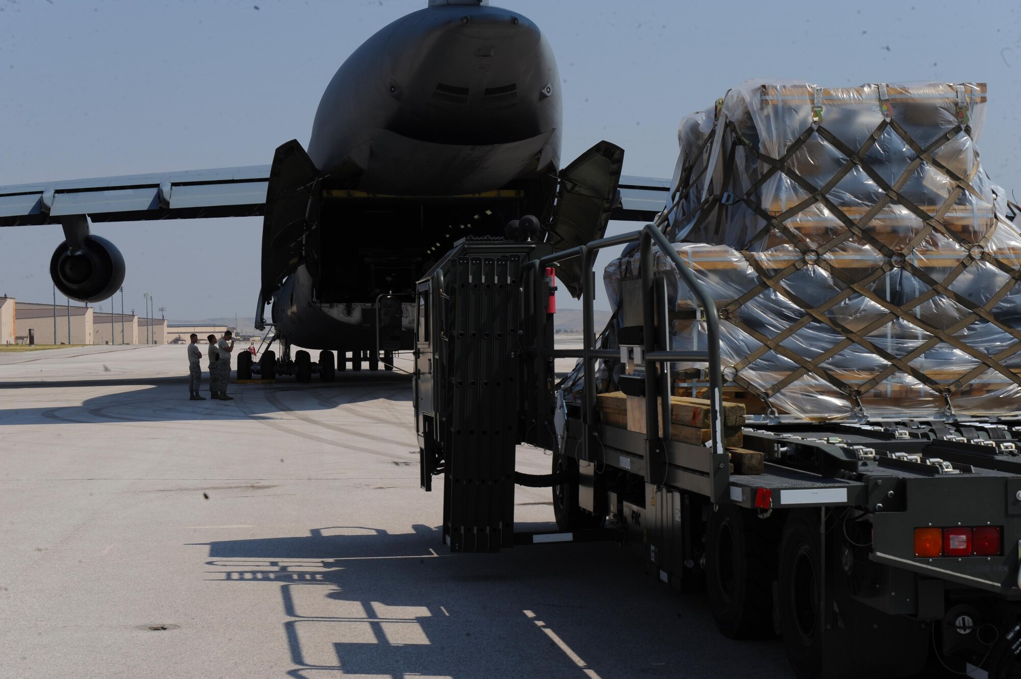 Airmen assigned to the 22nd Airlift Squadron, Travis Air Force Base, Calif., load cargo onto a C-5M Super Galaxy at Ellsworth Air Force Base, S.D., July 22, 2017. More than 350 Airmen deployed to Andersen Air Force Base, Guam, in support of the Continuous Bomber Presence mission in the Pacific. (U.S. Air Force photo by Airman Nicolas Z. Erwin)