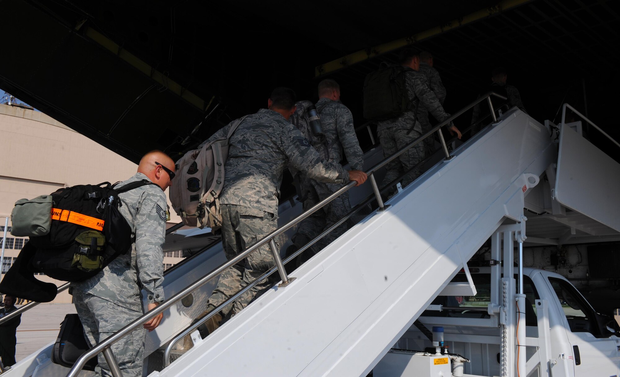 Airmen from the 28th Bomb Wing at Ellsworth Air Force Base, S.D., board a C-5 Super Galaxy bound for Andersen Air Force Base, Guam, in support of Continuous Bomber Presence operations in the Pacific theater, July 22, 2017. This deployment marks the third rotation of B-1 Bombers deploying to the Pacific. (U.S. Air Force photo by Airman Nicolas Z. Erwin)