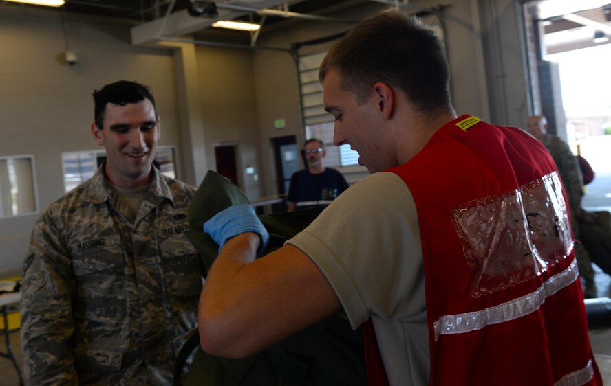 Airman 1st Class Michael Marrino, a line delivery crew member assigned to the 37th Expeditionary Bomb Squadron, has his luggage searched inside the Deployment Center at Ellsworth Air Force Base, S.D., July 28, 2017. The Airmen who deployed to Andersen Air Force Base, Guam, will support Continuous Bomber Presence operations in the Pacific region. (U.S. Air Force photo by Airman Nicolas Z. Erwin)