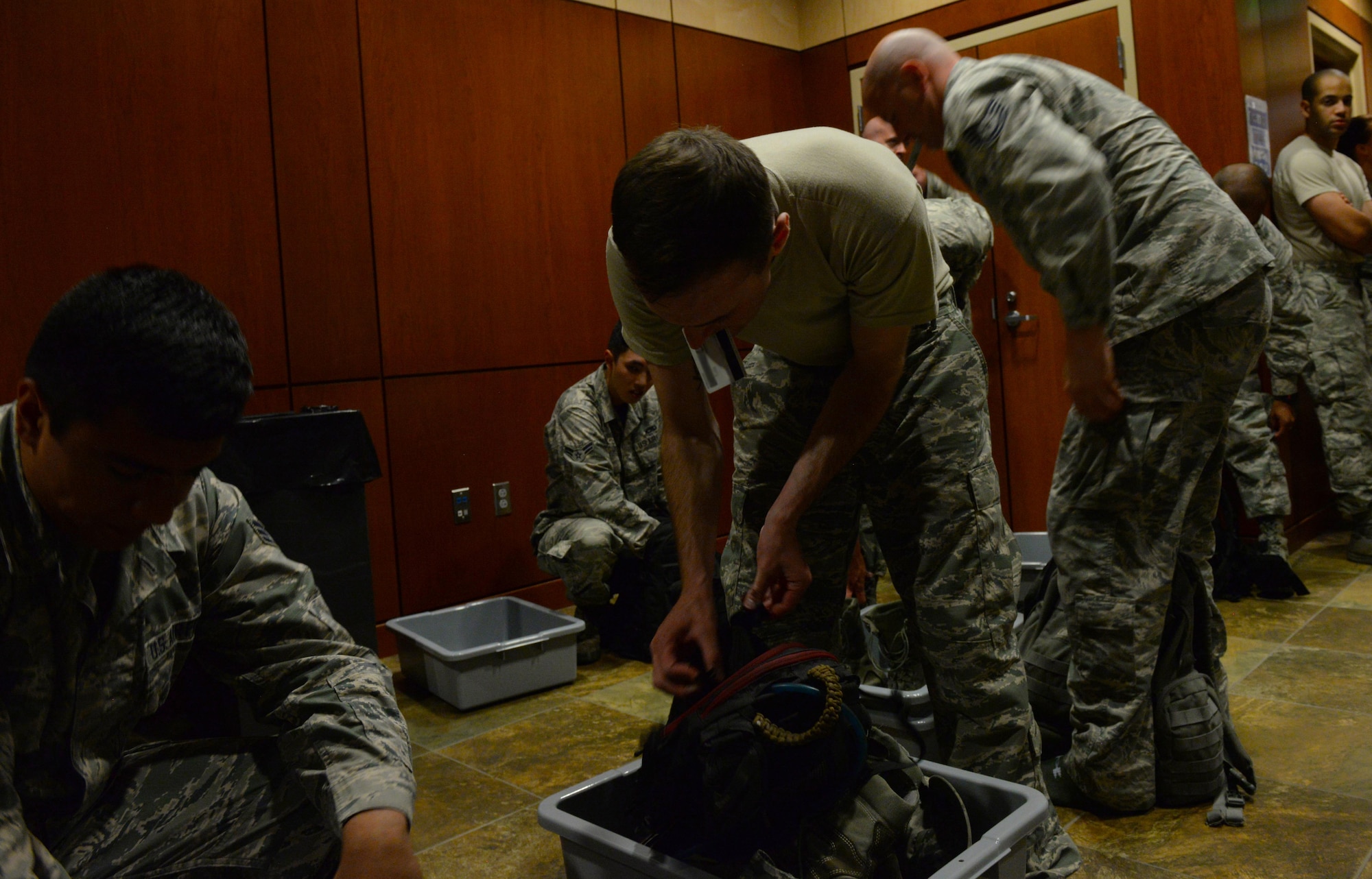 Staff Sgt. Tyler Sandberg, quality assurance assigned to the 37th Expeditionary Bomb Squadron, separates some of his carry-on luggage before processing through a sterilization room of the Deployment Center at Ellsworth Air Force Base, S.D., July 28, 2017. Ellsworth Airmen assigned to the 37th Expeditionary Bomb Squadron take the baton from the 9th Expeditionary Bomb Squadron, Dyess Air Force Base, Texas, for ongoing Continuous Bomb Presence missions occurring in U.S. Pacific Command. (U.S. Air Force photo by Airman Nicolas Z. Erwin)