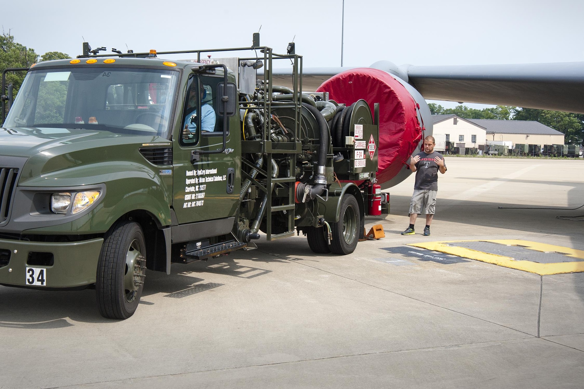 Tech. Sgt. Thomas Conroy, 459th Aircraft Maintenance Squadron crew chief, guides a fuel truck into place prior to refueling a KC-135R Stratotanker on the Joint Base Andrews, Maryland, flight line July 20, 2017. The truck contains a hydraulic system used to draw fuel from underground reservoirs into the aircraft. (U.S Air Force photo/Tech. Sgt. Kat Justen)