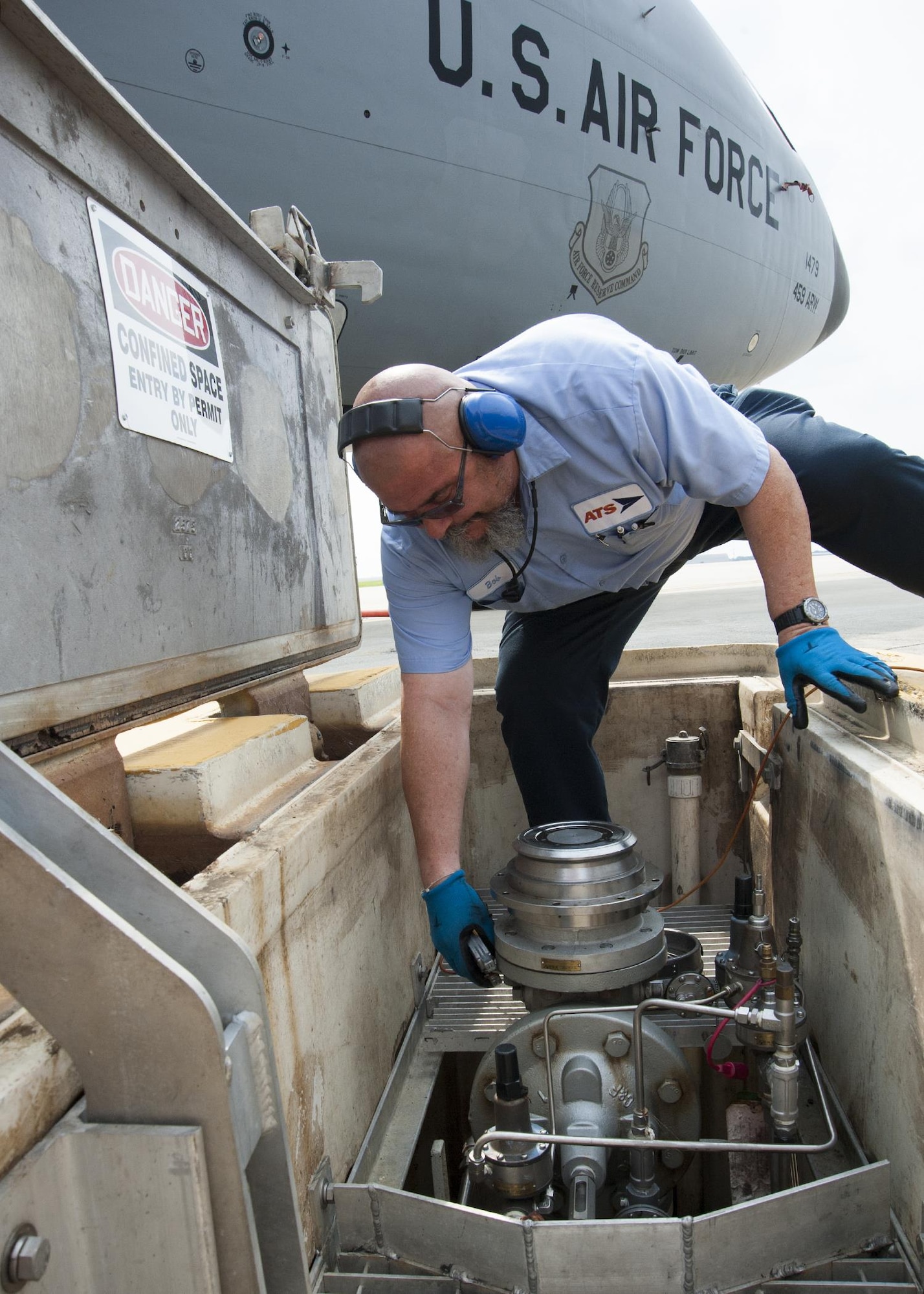 Bob Taylor, Akima Technical Solutions fuel distribution systems operator, pulls a hydrant servicing coupler to a hydrant outlet adapter prior to refueling a 459th Air Refueling Wing KC-135R Stratotanker on the Joint Base Andrews, Maryland, flight line July 20, 2017. The KC-135 is an aerial refueling aircraft capable of holding 200,000 pounds of fuel which is drawn from underground reservoirs and onto the aircraft via a refueling truck. (U.S Air Force photo/Tech. Sgt. Kat Justen)