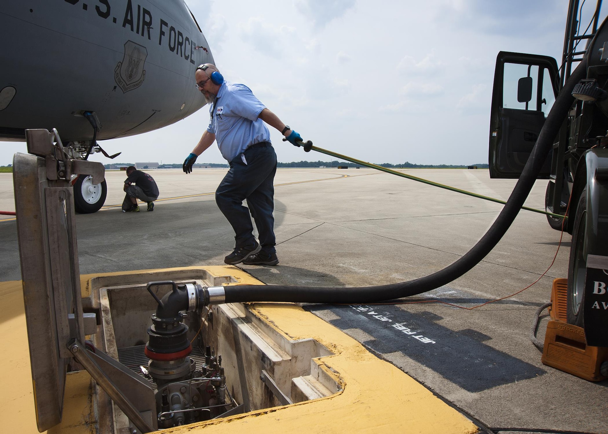 Bob Taylor, Akima Technical Solutions fuel distribution systems operator, pulls fuel and air sensing lines to a fuel hydrant system on the Joint Base Andrews, Maryland, flight line prior to refueling a 459th Air Refueling Wing KC-135R Stratotanker July 20, 2017. The KC-135 is an aerial refueling aircraft capable of holding up to 200,000 pounds of fuel. (U.S Air Force photo/Tech. Sgt. Kat Justen)