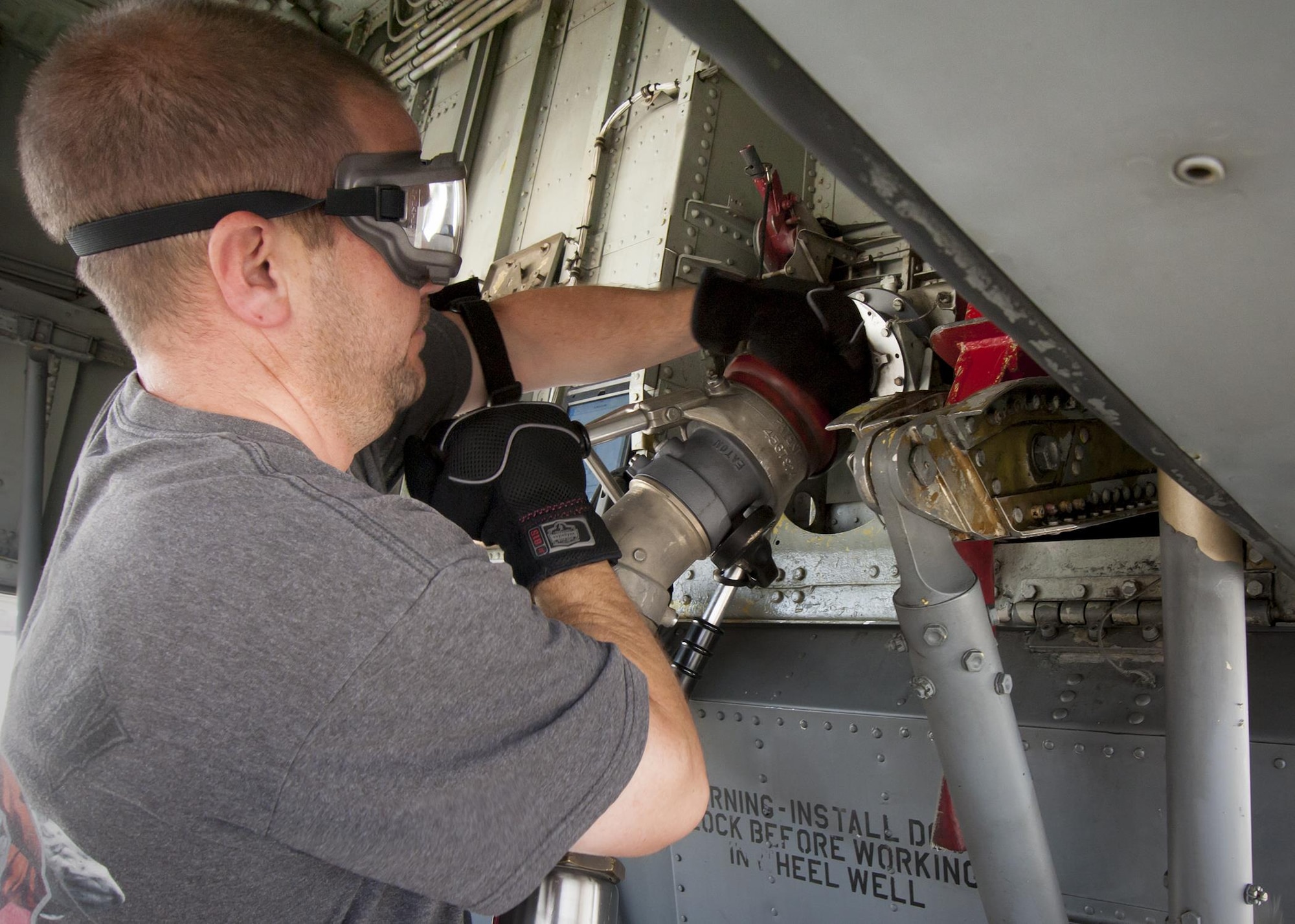 Tech. Sgt. Thomas Conroy, 459th Aircraft Maintenance Squadron crew chief, attaches a fuel line to a KC-135R Stratotanker prior to refueling on the Joint Base Andrews, Maryland, flight line July 20, 2017. The KC-135 is refueled using a truck equipped with a hydraulic system to draw fuel from an underground reservoir onto the aircraft. (U.S Air Force photo/Tech. Sgt. Kat Justen)