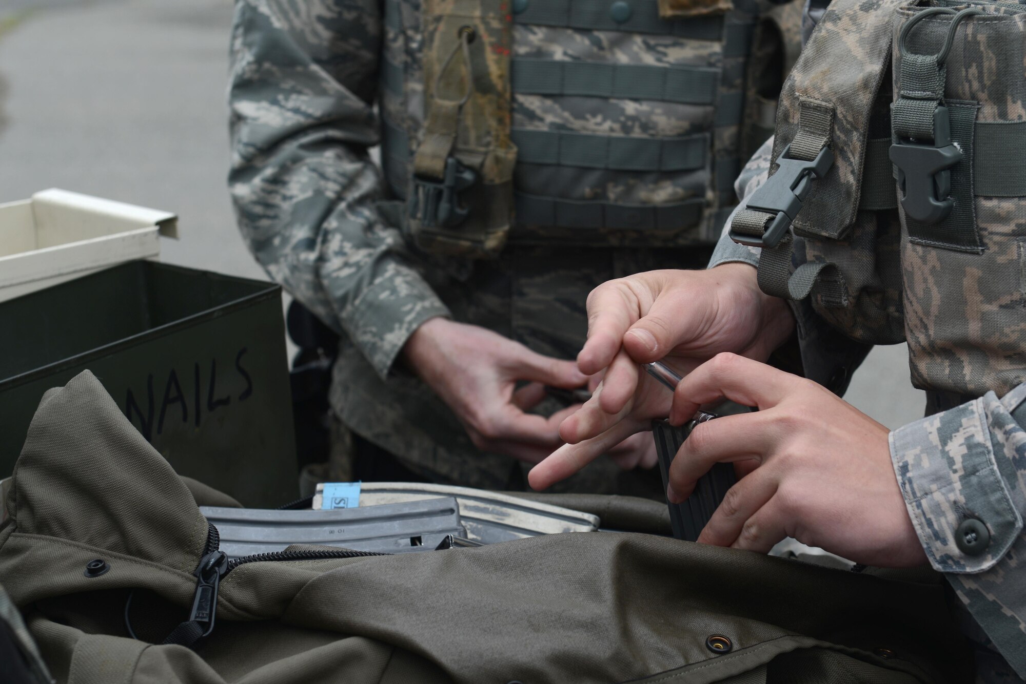 A few 673d Security Forces Squadron members load Simunition marking cartridges in preparation for active-shooter training at Joint Base Elmendorf-Richardson, Alaska, July 18, 2017. All participants were issued proper protective gear, to include a helmet, neck guard and gloves. 