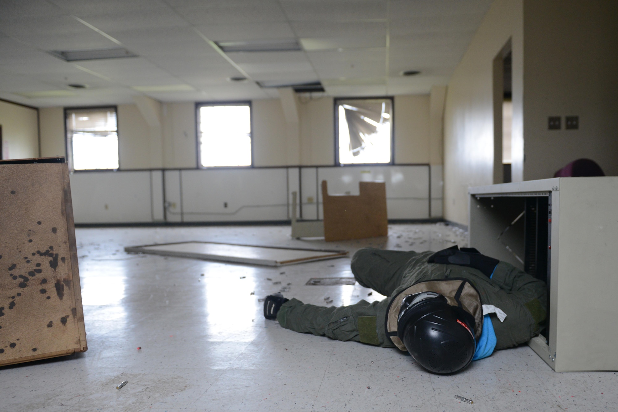 A volunteer lies on the ground after a simulated fire fight during 673d Security Forces Squadron active-shooter training at Joint Base Elmendorf-Richardson, Alaska, July 18, 2017. Volunteers created chaotic scenarios with no more than two perpetrators and several hostages at a time to challenge security forces. 