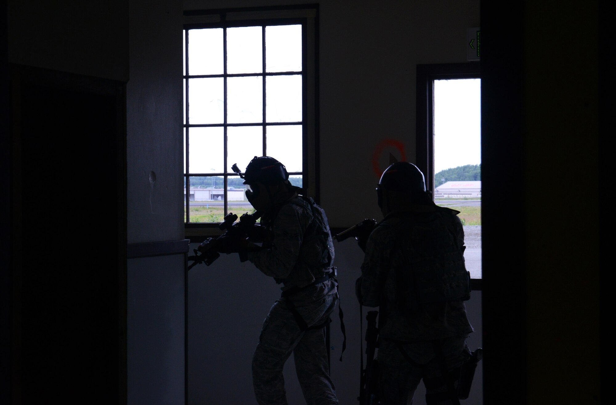 A team of 673d Security Forces Squadron members sweep a room during active-shooter training at Joint Base Elmendorf-Richardson, Alaska, July 18, 2017. Security forces trained in high-stress environments with hostages and aggressive perpetrators, so they learned how to appropriately respond and handle various hostile situations. 