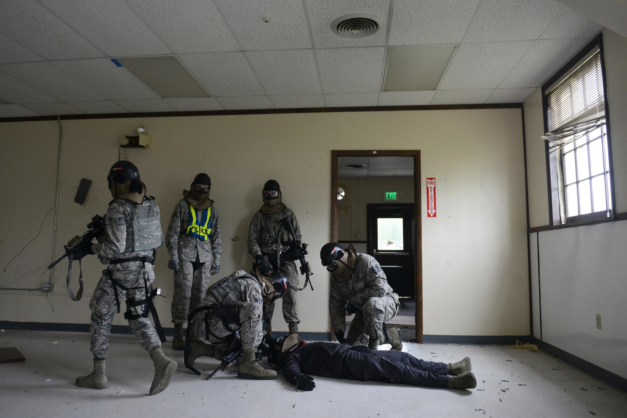 A team of 673d Security Forces Squadron members identify the condition of a simulated perpetrator during active-shooter training at Joint Base Elmendorf-Richardson, Alaska, July 18, 2017. Security forces trained in high-stress environments with hostages and aggressive perpetrators so they learned how to appropriately respond and handle various hostile situations. (U.S. Air Force photo by Airman 1st Class Christopher R. Morales)
