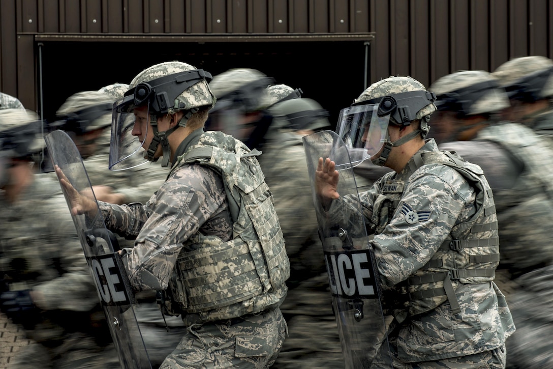 Airmen maneuver in formation during riot control training at Ramstein Air Base, Germany, July 25, 2017. The airmen are assigned to the 86th Security Forces Squadron. Air Force photo by Senior Airman Devin Boyer
