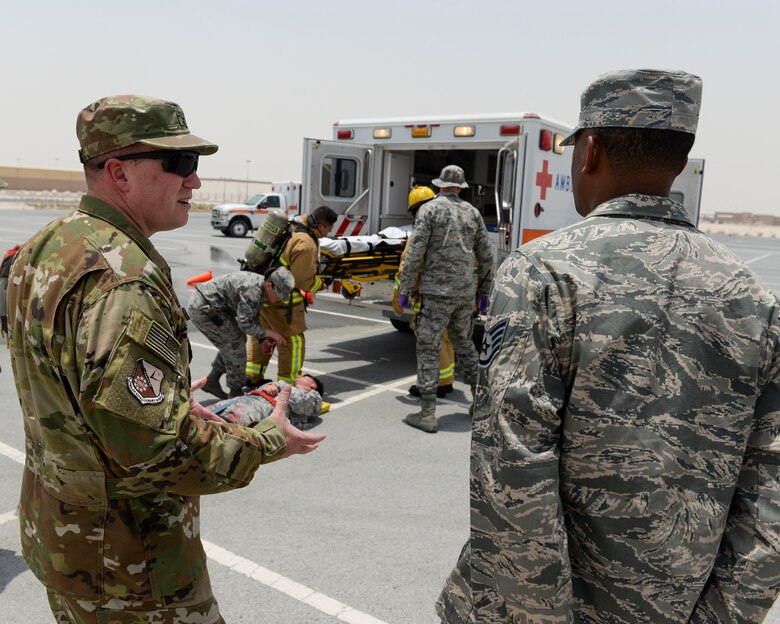 U.S. Air Force Vice Commander Col. Jeffrey Schreiner, foreground left, assigned to the 379th Air Expeditionary Wing and Staff Sgt. Deshawn Stallworth, fire fighter, assigned 379th Expeditionary Civil Engineer Squadron discuss the emergency response exercise held at Al Udeid Air Base, Qatar, July 26, 2017. The exercise was designed to demonstrate base 911 response capabilities to the Vice Commander and the Command Chief of the 379th Air Expeditionary Wing. (U.S. Air National Guard photo by Tech. Sgt. Bradly A. Schneider/Released)