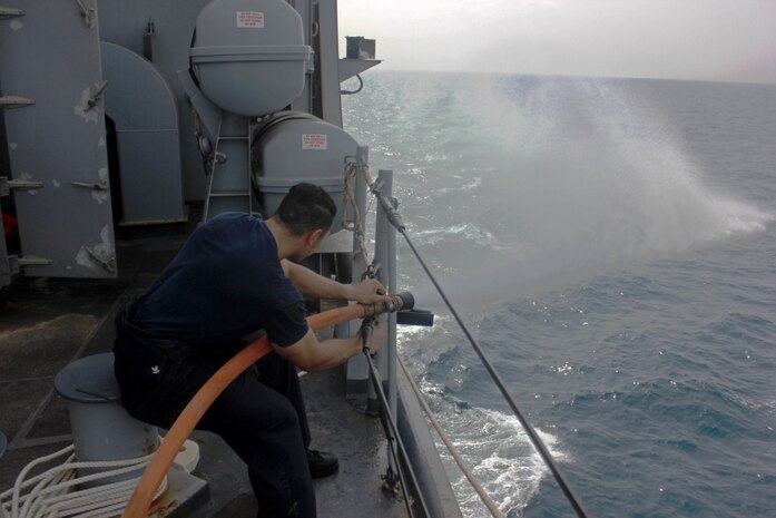 U.S. 5TH FLEET AREA OF OPERATIONS (July 23, 2017) Damage Controlman 3rd Class Devonte Llanes conducts a firemain flush aboard the amphibious dock landing ship USS Carter Hall (LSD 50). Carter Hall, part of the Bataan Amphibious Ready Group, is deployed to the U.S. 5th Fleet area of operations in support of maritime security operations to reassure allies and partners, and preserve the freedom of navigation and the free flow of commerce in the region. (U.S. Navy photo by Mass Communication Specialist 3rd Class Jelani J. McRaeQuiles) 