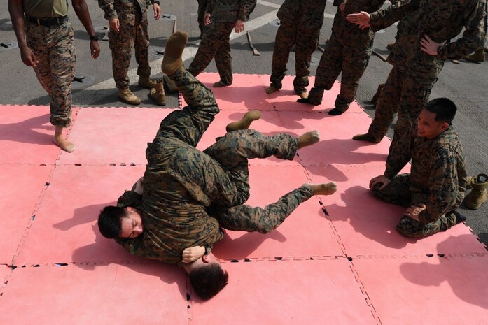 U.S. 5TH FLEET AREA OF OPERATIONS (July 20, 2017) Marines assigned to the 24th Marine Expeditionary Unit practice combat techniques during Marine Corps Martial Arts Program training on the flight deck aboard the amphibious dock landing ship USS Carter Hall (LSD 50). Carter Hall, part of the Bataan Amphibious Ready Group, is deployed to the U.S. 5th Fleet area of operations in support of maritime security operations to reassure allies and partners, and preserve the freedom of navigation and the free flow of commerce in the region. (U.S. Navy photo by Mass Communication Specialist 1st Class Darren M. Moore) 