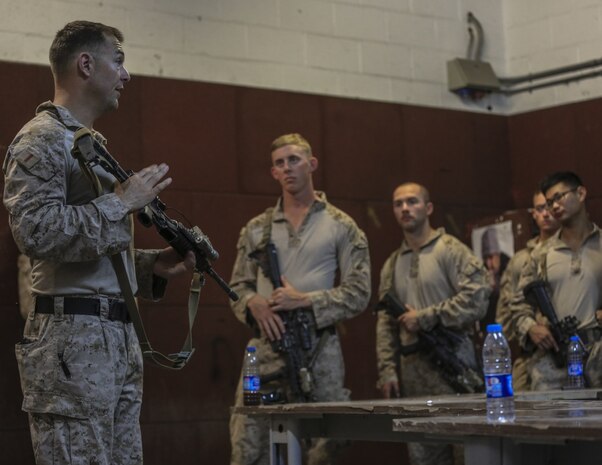 U.S. 5TH FLEET AREA OF OPERATIONS - U.S. Marine Corps Chief Warrant Officer 2 Mark Erhardt, Battalion Gunner with 1st Battalion, 7th Marine Regiment, Special Purpose Marine Air-Ground Task Force-Crisis Response-Central Command, discusses room clearing and close quarter combat tactics with Marines in Jordan, July 19, 2017. This training ensures SPMAGTF-CR-CC Marines sustain vital skills to enhance their ability to react to any mission they may encounter while conducting USCENTCOM’s crisis response mission. (U.S. Marine Corps photo by Cpl. Kyle McNan) 