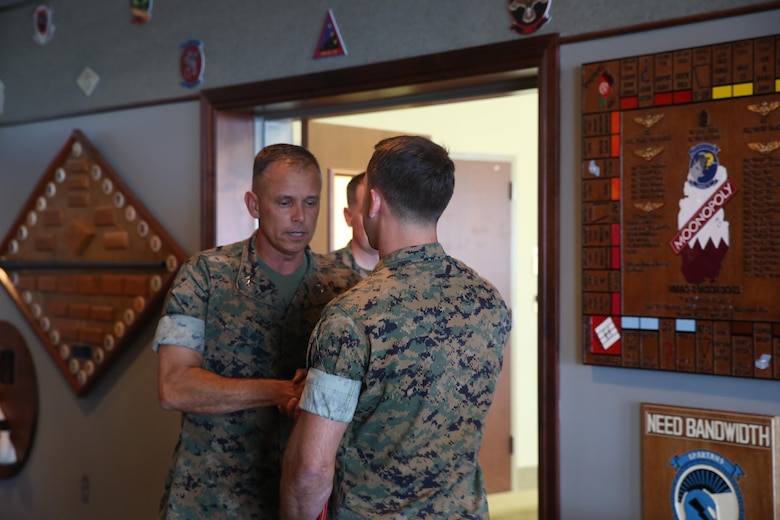 Maj. Gen. Matthew Glavy, shakes the hand of Capt. Peter Abramovs during an awards ceremony aboard Marine Corps Air Station Cherry Point, N.C., July 28, 2017. Abramovs was awarded the Air Medal for rescuing multiple Marines when his MV-22 Osprey experienced a hard landing on May 17, 2015. Abramovs was injured in the landing, but charged into the burning wreckage to help his fellow Marines. Glavy is the commanding general of 2nd Marine Aircraft Wing, and Abramovs is an AV-8B Harrier II pilot with Marine Attack Squadron 231, Marine Aircraft Group 14, 2nd MAW. (U.S. Marine Corps Photo by Pfc. Skyler Pumphret/ Released)