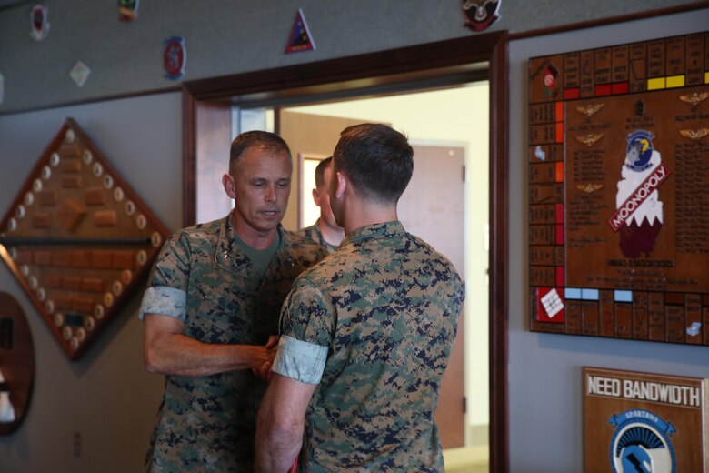 Maj. Gen. Matthew Glavy, shakes the hand of Capt. Peter Abramovs during an awards ceremony aboard Marine Corps Air Station Cherry Point, N.C., July 28, 2017. Abramovs was awarded the Air Medal for rescuing multiple Marines when his MV-22 Osprey experienced a hard landing on May 17, 2015. Abramovs was injured in the landing, but charged into the burning wreckage to help his fellow Marines. Glavy is the commanding general of 2nd Marine Aircraft Wing, and Abramovs is an AV-8B Harrier II pilot with Marine Attack Squadron 231, Marine Aircraft Group 14, 2nd MAW. (U.S. Marine Corps Photo by Pfc. Skyler Pumphret/ Released)