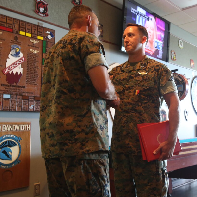 Maj. Gen. Matthew Glavy, shakes the hand of Capt. Peter Abramovs after awarding him the Air Medal at Marine Corps Air Station Cherry Point, N.C., July 28, 2017. Abramovs was awarded the Air Medal for rescuing multiple Marines when his MV-22 Osprey experienced a hard landing on May 17, 2015. Abramovs was injured in the landing, but charged into the burning wreckage to help his fellow Marines. Glavy is the commanding general of 2nd Marine Aircraft Wing, and Abramovs is an AV-8B Harrier II pilot with Marine Attack Squadron 231, Marine Aircraft Group 14, 2D MAW. (U.S. Marine Corps Photo by Pfc. Skyler Pumphret/ Released)
