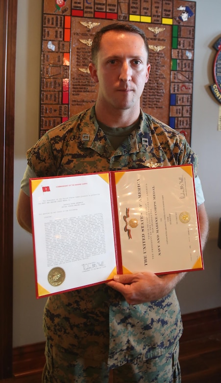 Capt. Peter Abramovs poses after being awarded the Air Medal during an awards ceremony at Marine Corps Air Station Cherry Point, N.C., July 28, 2017. Abramovs was awarded the Air Medal for helping his fellow Marines escape the flaming wreckage of their MV-22 Osprey on May 17, 2017. The aircraft experienced a hard landing during a training exercise at Marine Corps Training Area Bellows, O’ahu, Hawai’i. Abramovs is an AV-8B Harrier II pilot assigned to Marine Attack Squadron 231, Marine Aircraft Group 14, 2nd Marine Aircraft Wing. (U.S. Marine Corps Photo by Pfc. Skyler Pumphret/ Released)