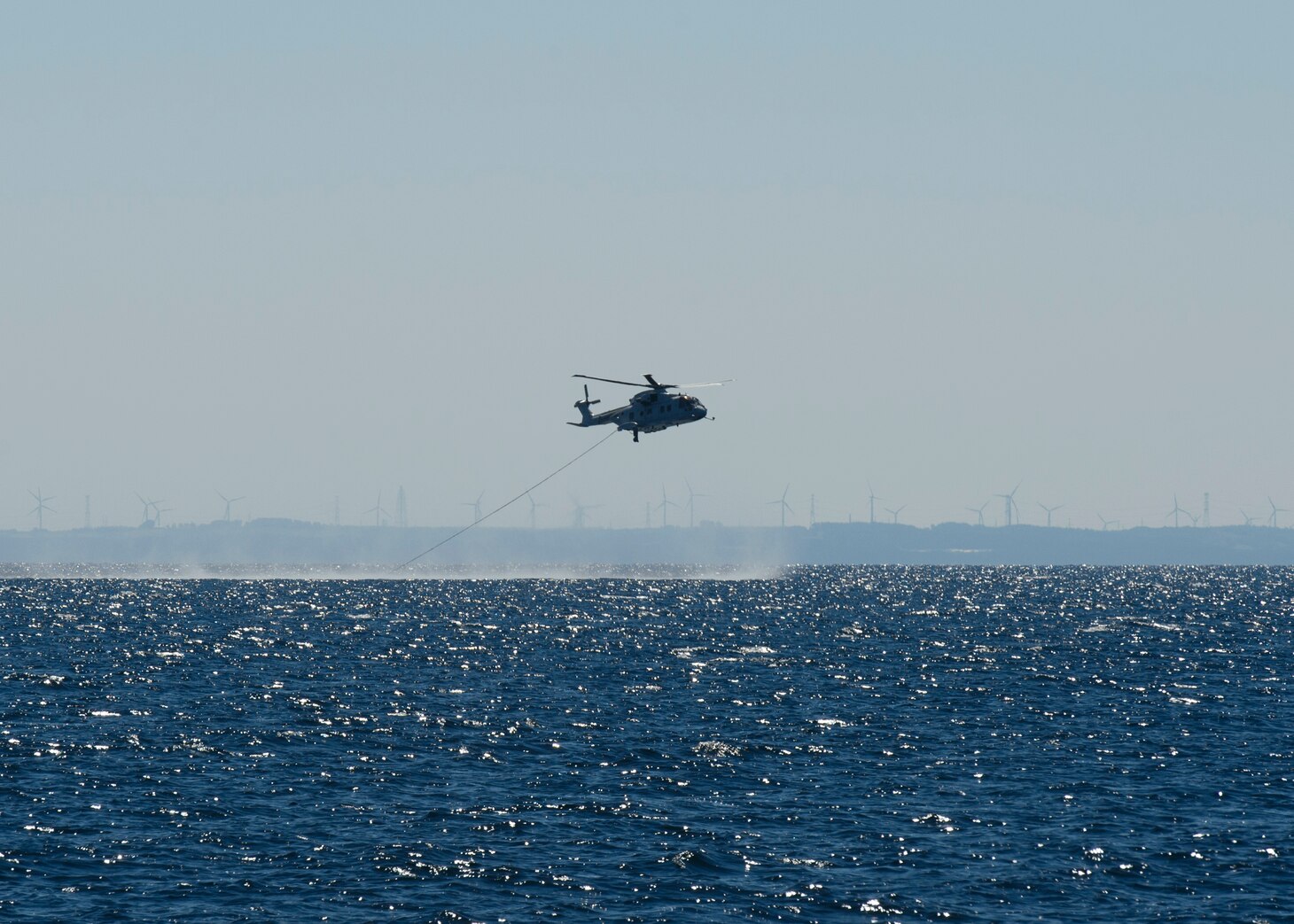 MUTSU, Japan (July 26, 2017) A JMSDF MCH-101 mine warfare helicopter rakes for mines in Mutsu Bay during 2JA 2017 Mine Countermeasures Exercise (2JA-17 MCMEX). 2JA Mine Countermeasures Exercise is an annual bilateral exercise held between the U.S. Navy and Japanese Maritime Self Defense Force to strengthen interoperability and increase proficiencies in mine countermeasure operations.