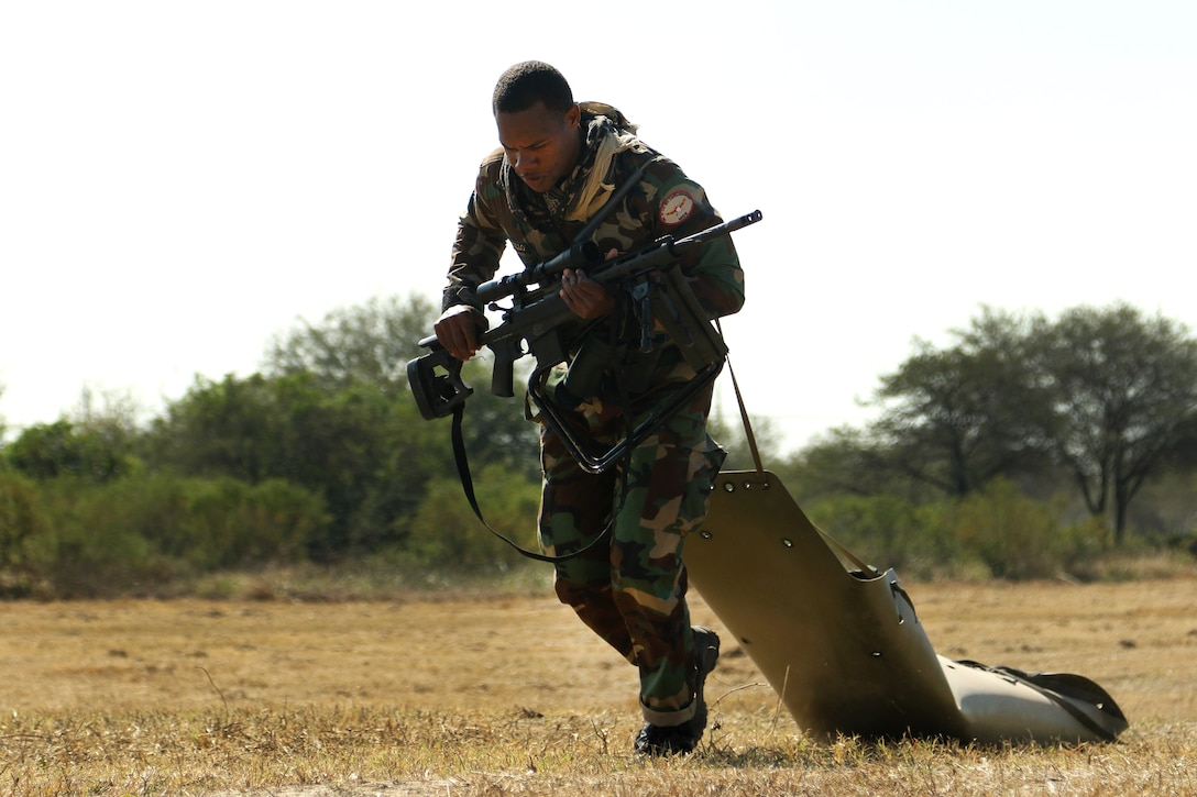 A member of the Dominican Republic's special operations team drags a litter during a timed sniper stress event, as part of Fuerzas Comando in Vista Alegre, Paraguay, July 21, 2017. Fuerzas Comando is a fellowship program that promotes military-to-military relationships for all teams involved. Army photo by Sgt. Christine Lorenz