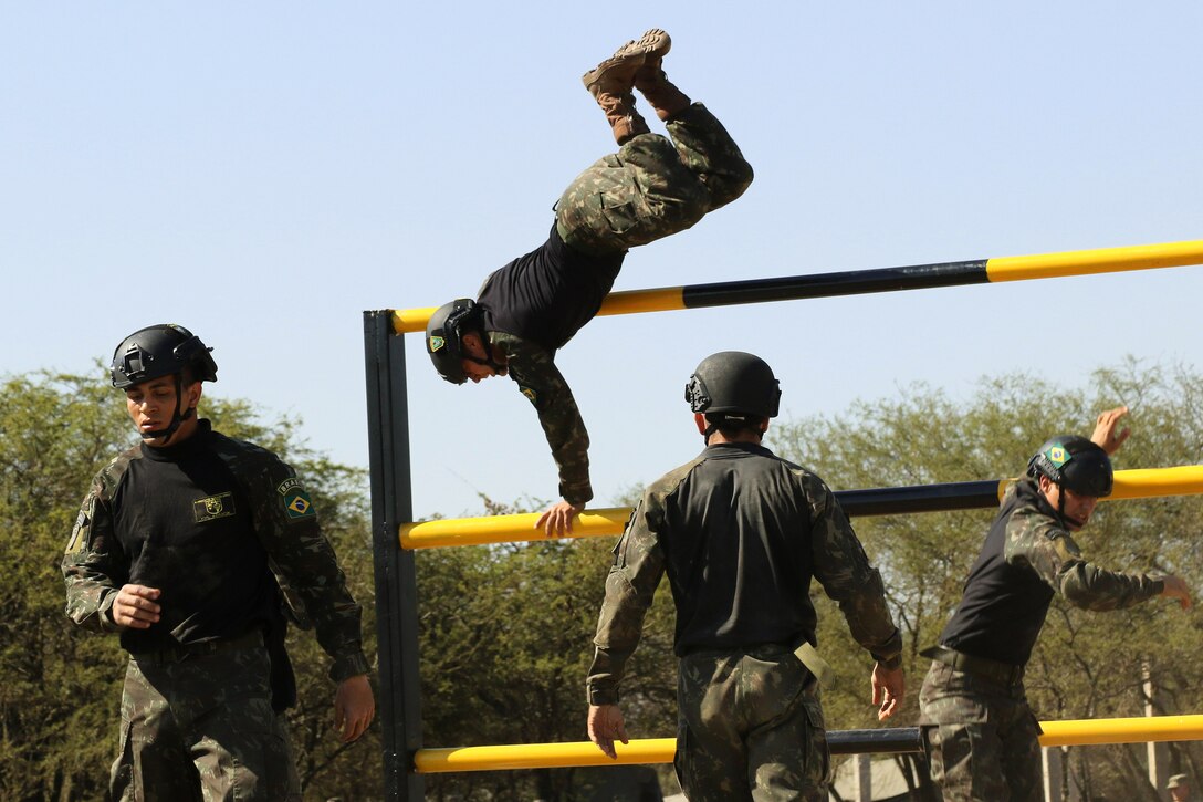 A member of the Brazilian special operations team hurdles over a bar on the obstacle course event during Fuerzas Comando 2017 in Vista Alegre, Paraguay, July 24, 2017. Army photo by Sgt. Joanna Bradshaw