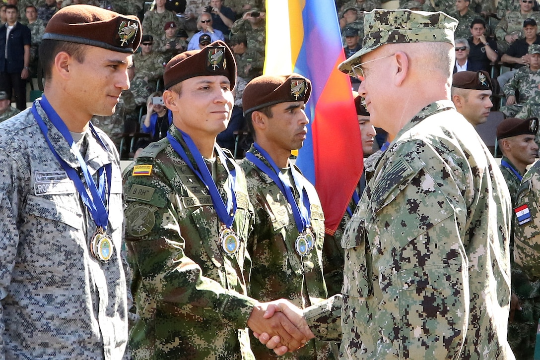U.S. Navy Adm. Kurt W. Tidd, right, commander of U.S. Southern Command, congratulates members of the Colombian special operations team during the closing ceremony in Mariano Roque Alonso, Paraguay, July 27, 2017. The Colombians finished in second place. Army photo by Sgt. Joanna Bradshaw