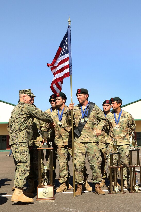 Navy Adm. Kurt W. Tidd, left, commander of U.S. Southern Command, shake hands and congratulates members of the U.S. special operations team after the closing ceremony of Fuerzas Comando in Mariano Roque Alonso, Paraguay, July 27, 2017. Army photo by Sgt. Joanna Bradshaw