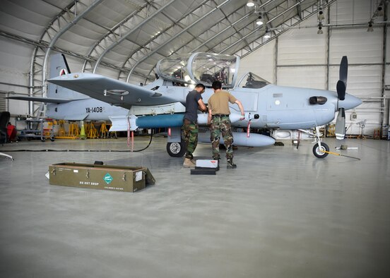 Two Afghan Air Force A-29 Super Tucano maintainers download GBU-12s (Guided Bomb Unit) at Kabul Air Wing, Afghanistan, July 26, 2017. Recently, AAF A-29 maintenance leadership requested to take full responsibility for flight line maintenance operations from Train, Advise, Assist Command-Air advisors and contract maintenance. This initiative by the maintainers is another step closer to the AAF becoming a professional, capable and sustainable force. (U.S. Air Force photo by Tech. Sgt. Veronica Pierce)