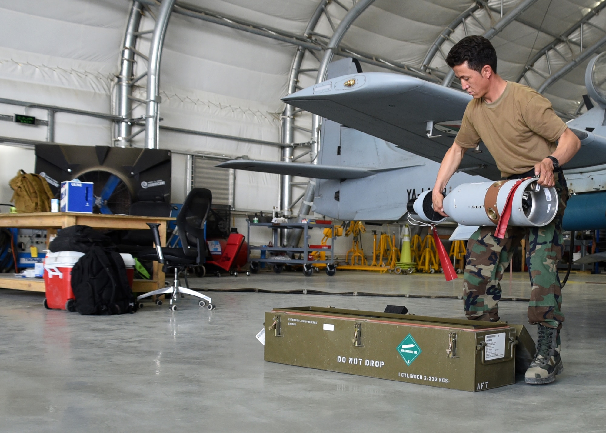 An Afghan Air Force A-29 Super Tucano maintainer downloads a GBU-12s (Guided Bomb Unit) at Kabul Air Wing, Afghanistan, July 26, 2017. Recently, AAF A-29 maintenance leadership requested to take full responsibility for flight line maintenance operations from Train, Advise, Assist Command-Air advisors and contract maintenance. This initiative by the maintainers is another step closer to the AAF becoming a professional, capable and sustainable force. (U.S. Air Force photo by Tech. Sgt. Veronica Pierce)