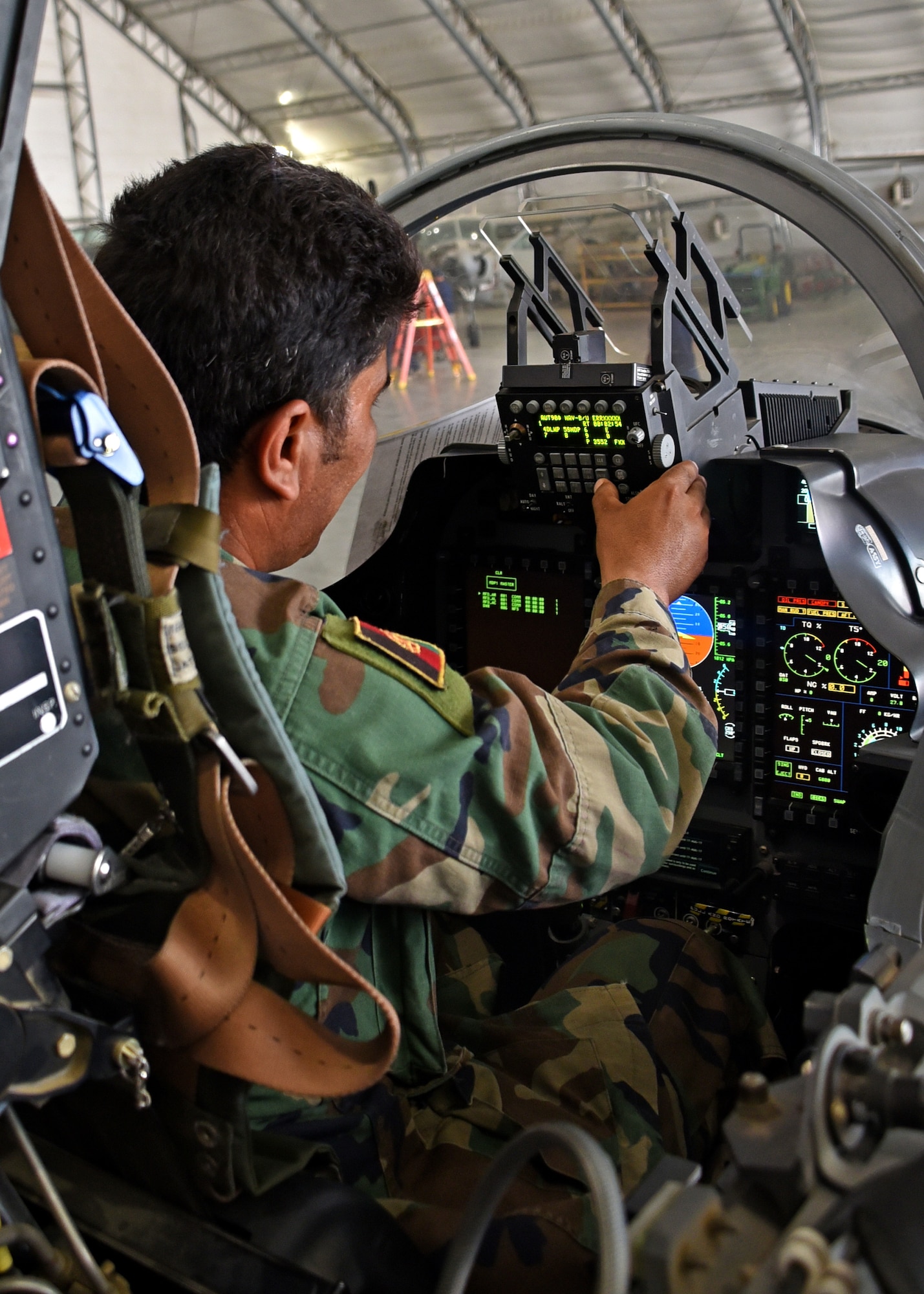 An Afghan Air Force A-29 Super Tucano maintainer performs an avionics check in the cockpit of the aircraft at Kabul Air Wing, Afghanistan, July 26, 2017. Recently, AAF A-29 maintenance leadership requested to take full responsibility for flight line maintenance operations from Train, Advise, Assist Command-Air advisors and contract maintenance. This initiative by the maintainers is another step closer to the AAF becoming a professional, capable and sustainable force. (U.S. Air Force photo by Tech. Sgt. Veronica Pierce)