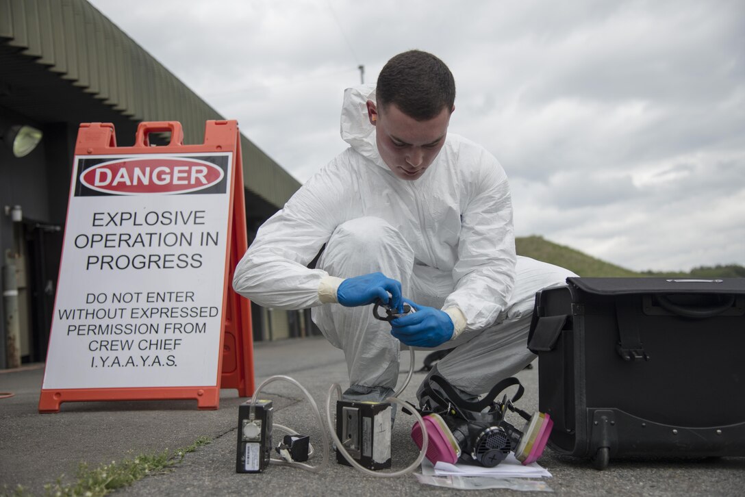 Senior Airman Petri Brand, a 35th Aerospace Medicine Squadron bioenvironmental engineer technician, prepares air quality testing equipment kit during a mandatory occupational health risk assessment of two Airmen sanding a precision guided munition at Misawa Air Base, Japan, May 11, 2017. Monthly water sampling and contingency operations are also among the duties Brand performs. (U.S. Air Force photo by Staff Sgt. Melanie A. Hutto)