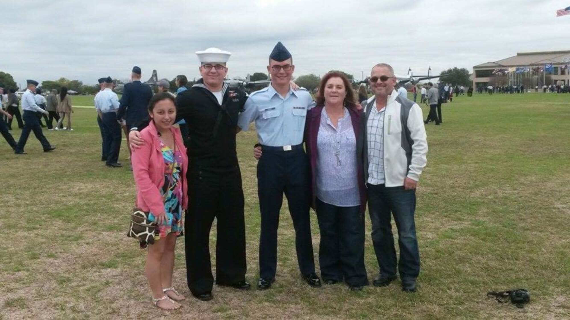 Senior Airman Petri Brand, a 35th Aerospace Medicine Squadron bioenvironmental engineer technician, and his family pause for a photo after his basic military training graduation at, Lackland Air Force Base, Texas. After basic Brand attended a nine-week long technical school and joined the operational Air Force upon arriving to Misawa Air Base. (Courtesy photo)