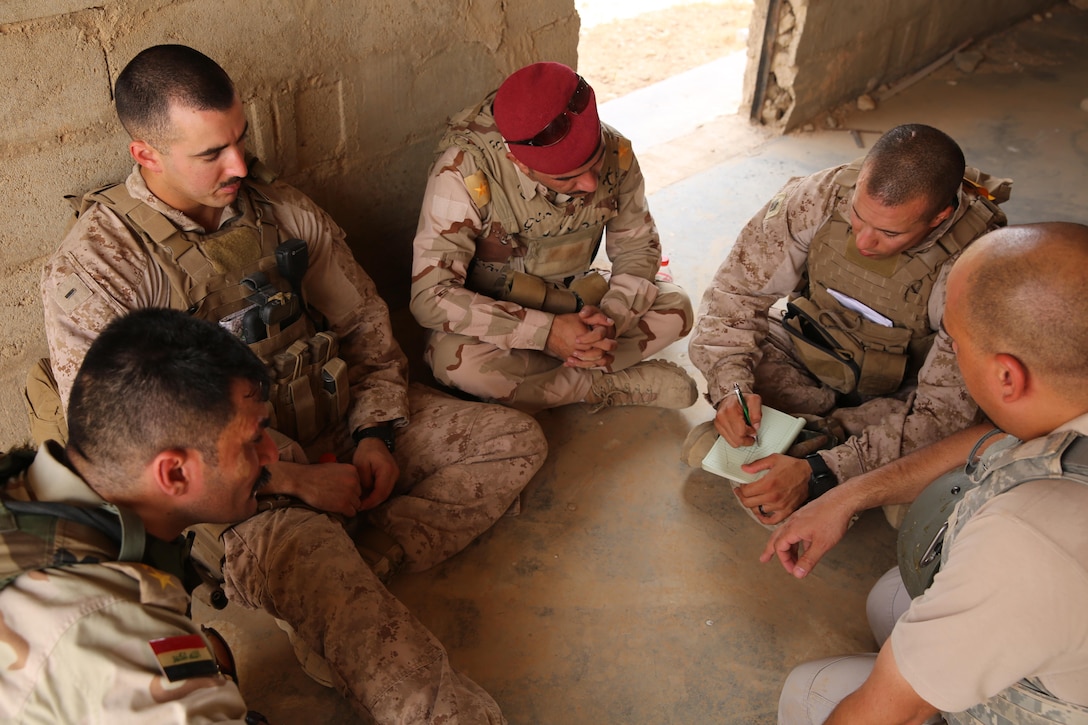 U.S. Marine Corps 1st Lt. Christian Castilla and Gunnery Sgt. Ryan Kirkham, the combined anti-armor team platoon commander and platoon sergeant attached to Task Force Al Asad with 1st Battalion, 7th Marine Regiment, Special Purpose Marine Air-Ground Task Force-Crisis Response-Central Command, conduct a de-brief with Iraqi officers of the 7th Iraqi Infantry Division at Al Asad Air Base, Iraq, July 7, 2017. These Marines are part of the Task Force’s coalition security force team in charge of providing security to the base and personnel onboard. Task Force Al Asad’s mission is to advise and assist and build partner capacity with the Iraqi Security Forces in Al Anbar province in support of Combined Joint Task Force-Operation Inherent Resolve, the global coalition to defeat ISIS in Iraq and Syria. (U.S. Marine Corps photo by 1st Lt. Dave Williams)